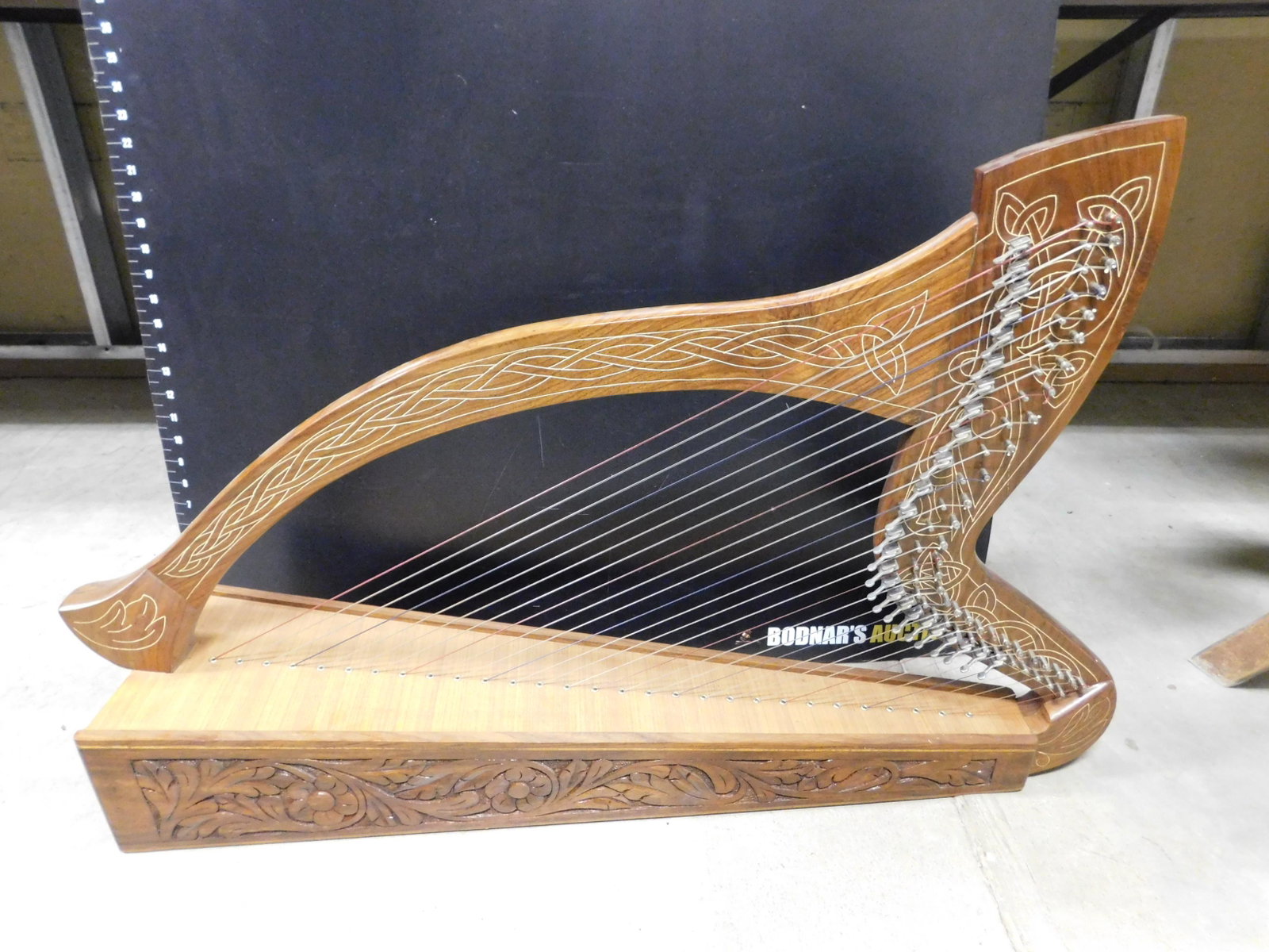 Carved and Inlay Small Harp: Carved and Inlay Wood Small Harp. Contemporary. Measures 23" tall x 38" wide. This sale will be broadcast live on sale day with full descriptions of each lot being sold, as well as video feed of each 