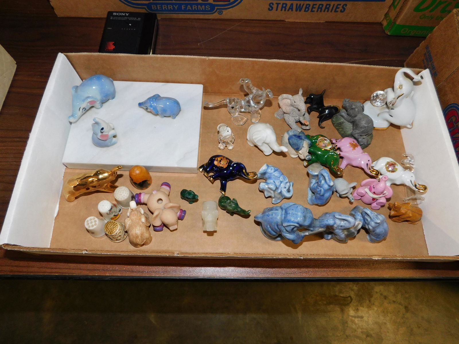 Box Lot of Miniature Elephants: Box Lot of Miniature Elephants. This sale will be broadcast live on sale day with an auctioneer and caller calling full descriptions of each lot being sold, as well as video feed of each lot. All item