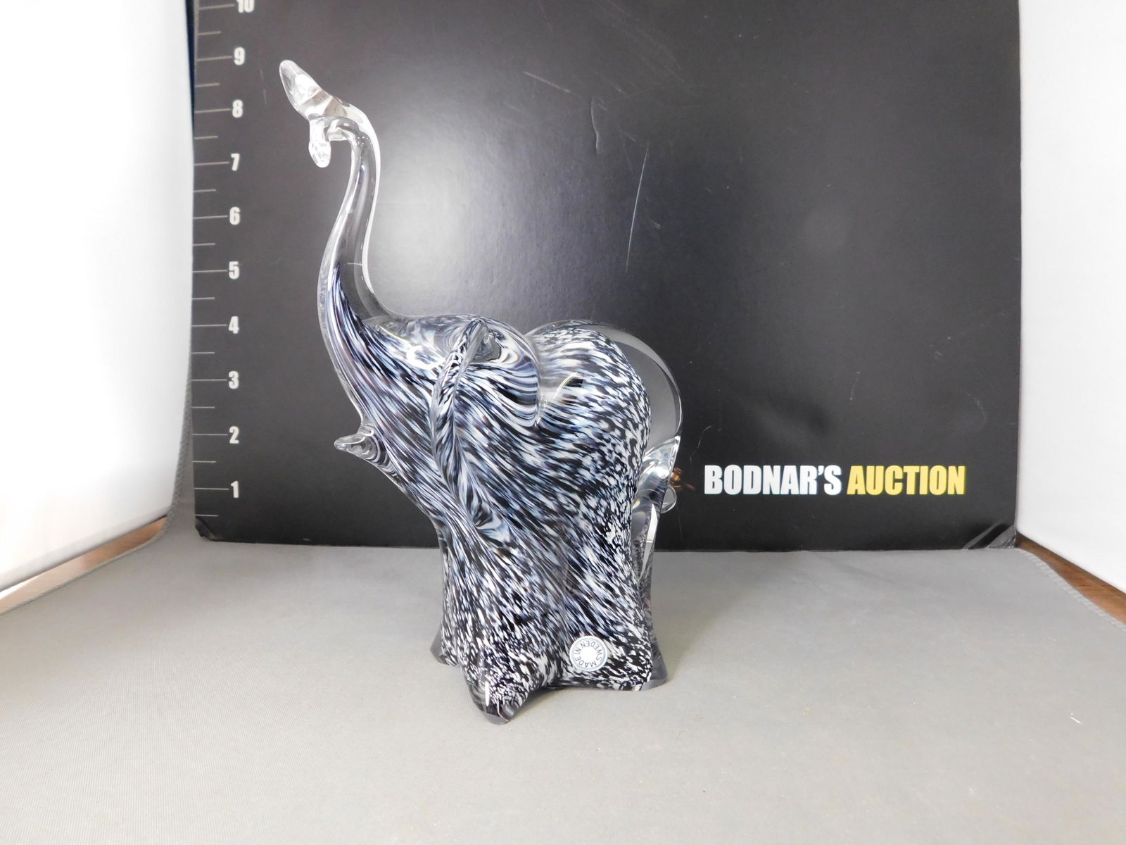 Mottled Glass Elephant: Mottled Glass Elephant. Made in Sweden. Measures 6.25" tall. This sale will be broadcast live on sale day with an auctioneer and caller calling full descriptions of each lot being sold, as well as vid