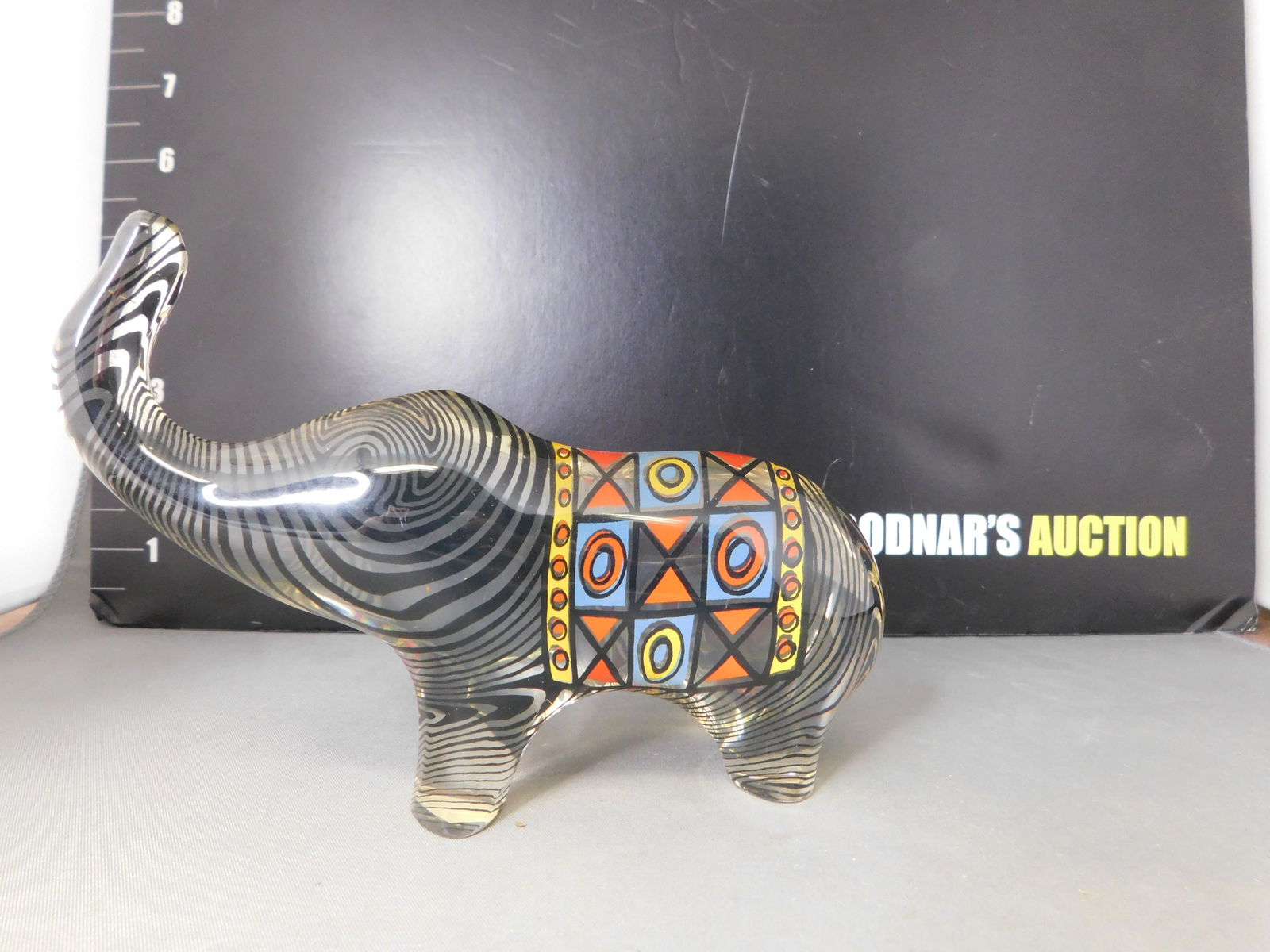Acrylic Elephant: Acrylic Elephant. Made in Brazil. Measures 4.25" tall. This sale will be broadcast live on sale day with an auctioneer and caller calling full descriptions of each lot being sold, as well as video fee