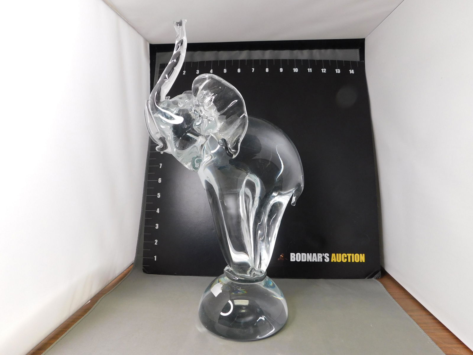 Art Glass Circus Elephant: Art Glass Circus Elephant. Signed with House Shaped Label. Measures 13" tall. This sale will be broadcast live on sale day with an auctioneer and caller calling full descriptions of each lot being sol