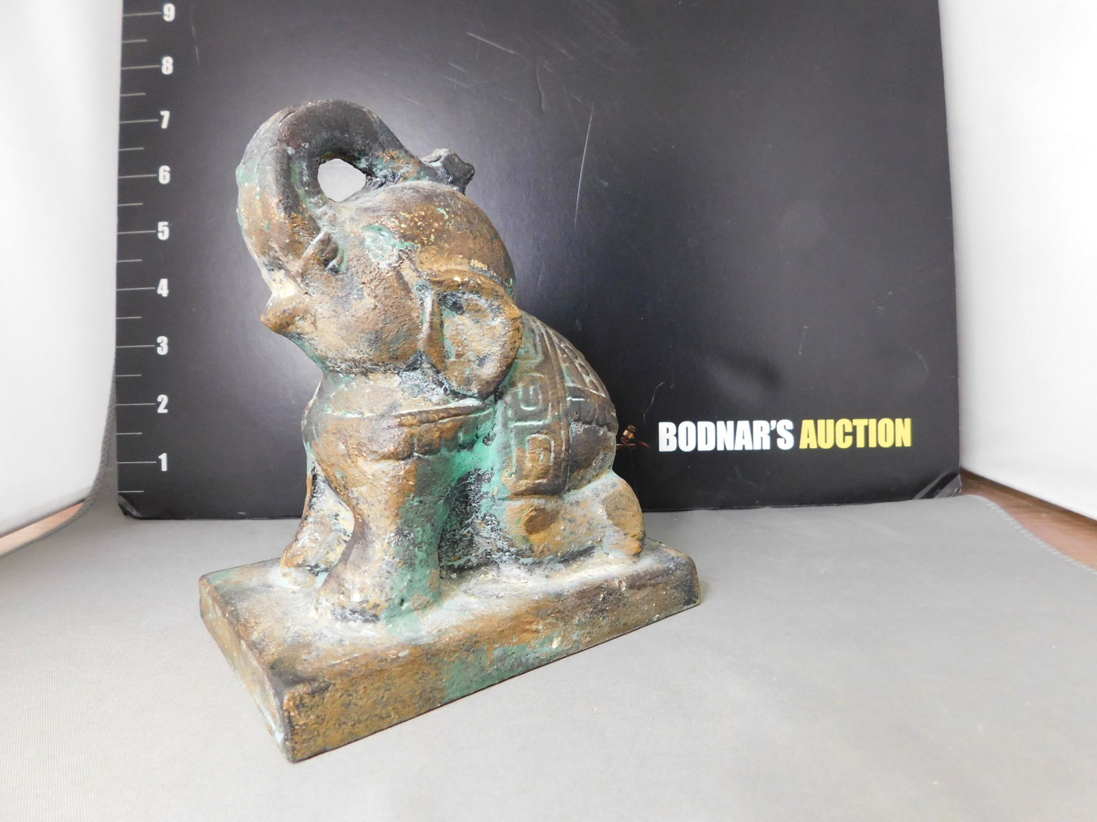 Cast Metal Elephant: Cast Metal Elephant. Asian Style. Marked Toyo Japan. Measures 5.75" tall. This sale will be broadcast live on sale day with an auctioneer and caller calling full descriptions of each lot being sold, a