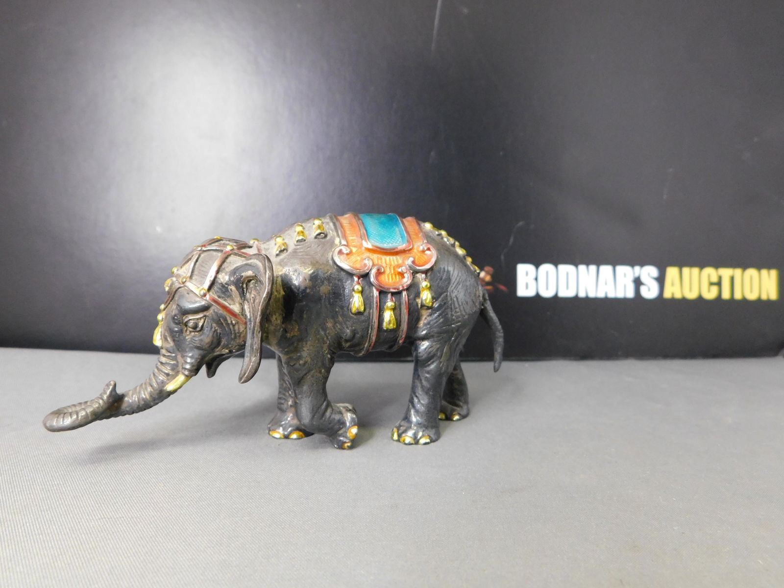 Sterling Tiffany & Co. Elephant: Sterling Tiffany & Co. Elephant. Has Enamel Embellishment. Measures 2.25" tall. This sale will be broadcast live on sale day with an auctioneer and caller calling full descriptions of each lot being s