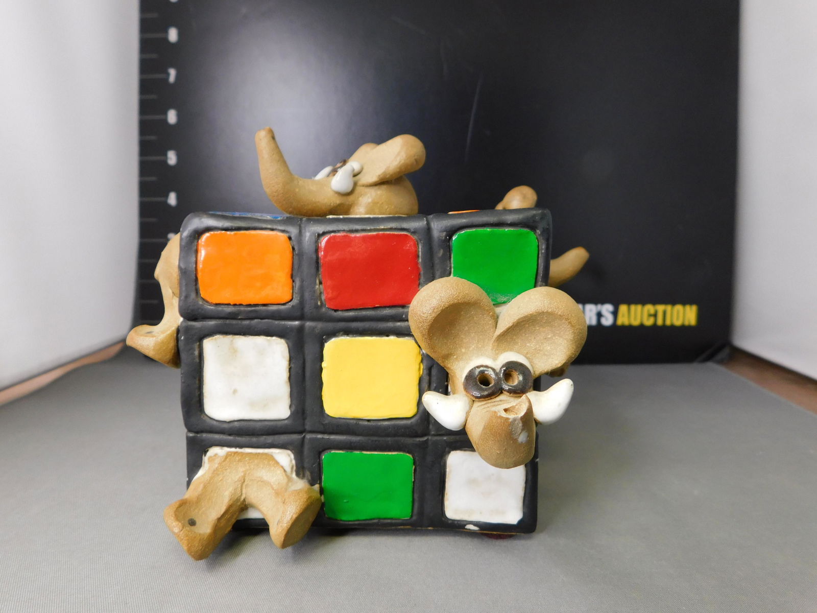 Ceramic Elephant in Rubik's Cube: Ceramic Elephants in Rubik's Cube. Signed on bottom Attwood. Measures 5" cubed. This sale will be broadcast live on sale day with an auctioneer and caller calling full descriptions of each lot being s