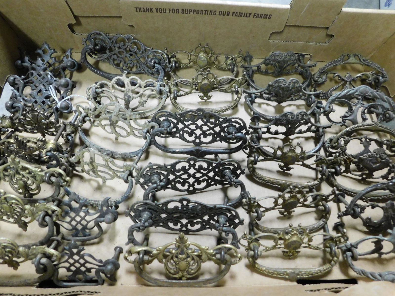 Box Lot of Brass Furniture Hardware: Box Lot of Brass Furniture Hardware. This sale will be broadcast live on sale day with an auctioneer and caller calling full descriptions of each lot being sold, as well as video feed of each lot. All