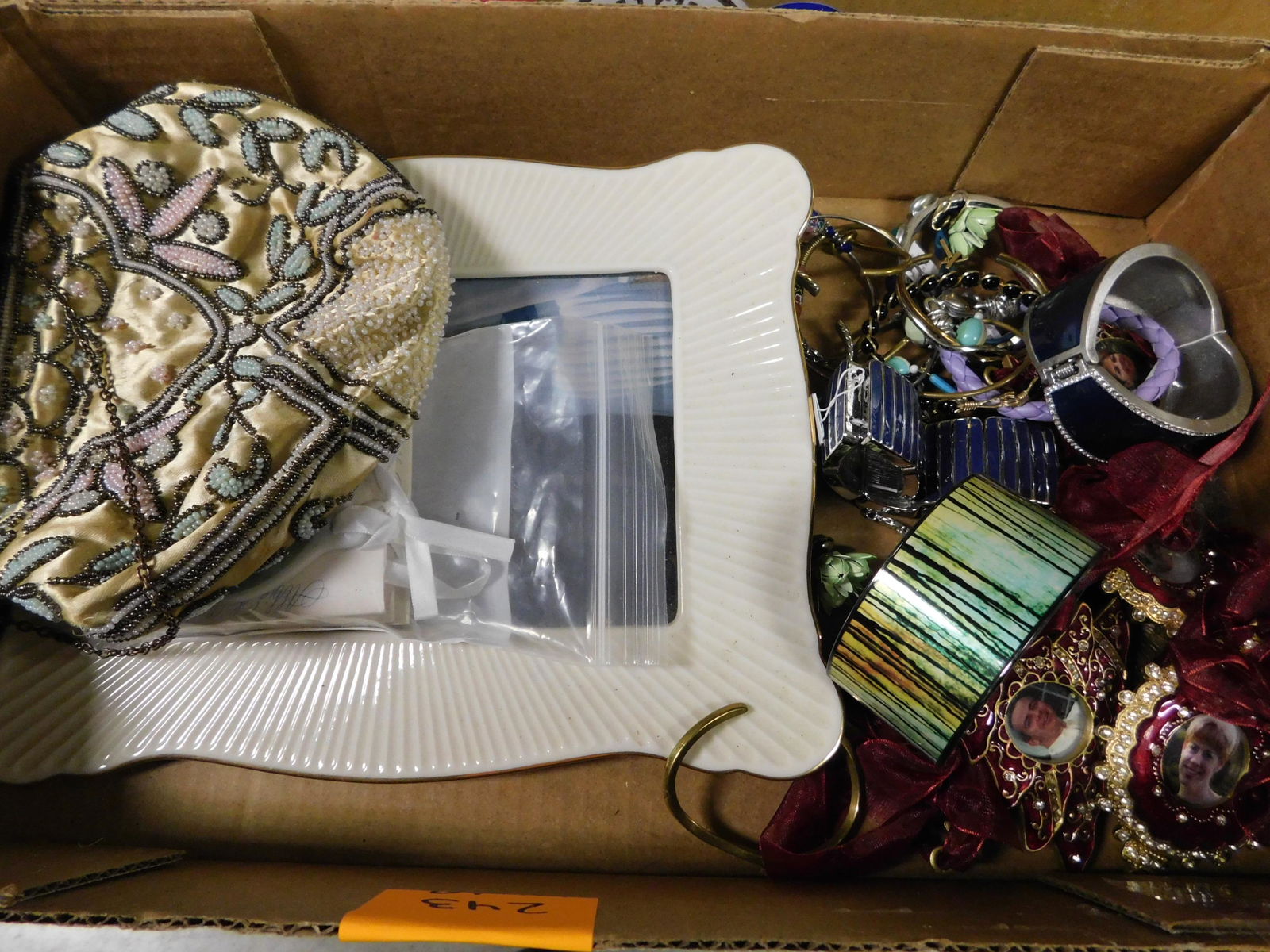 Box Lot with Costume Jewelry, Lenox and Beaded: Box Lot with Costume Jewelry, Beaded Pocketbook and Lenox. This sale will be broadcast live on sale day with an auctioneer and caller calling full descriptions of each lot being sold, as well as video