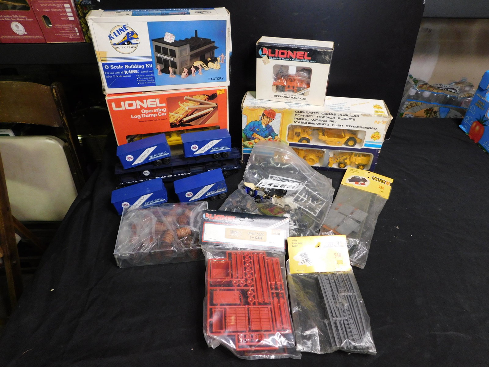 Lot of Lionel Trains and Accessories: Lot of Lionel Trains and Accessories including Lionel Lionel Operating Log Dump Car 9303, Operating Hand Car 18401, Auto Loader 1925. Also included is a Joal Construction Set in Box and Building Kits 