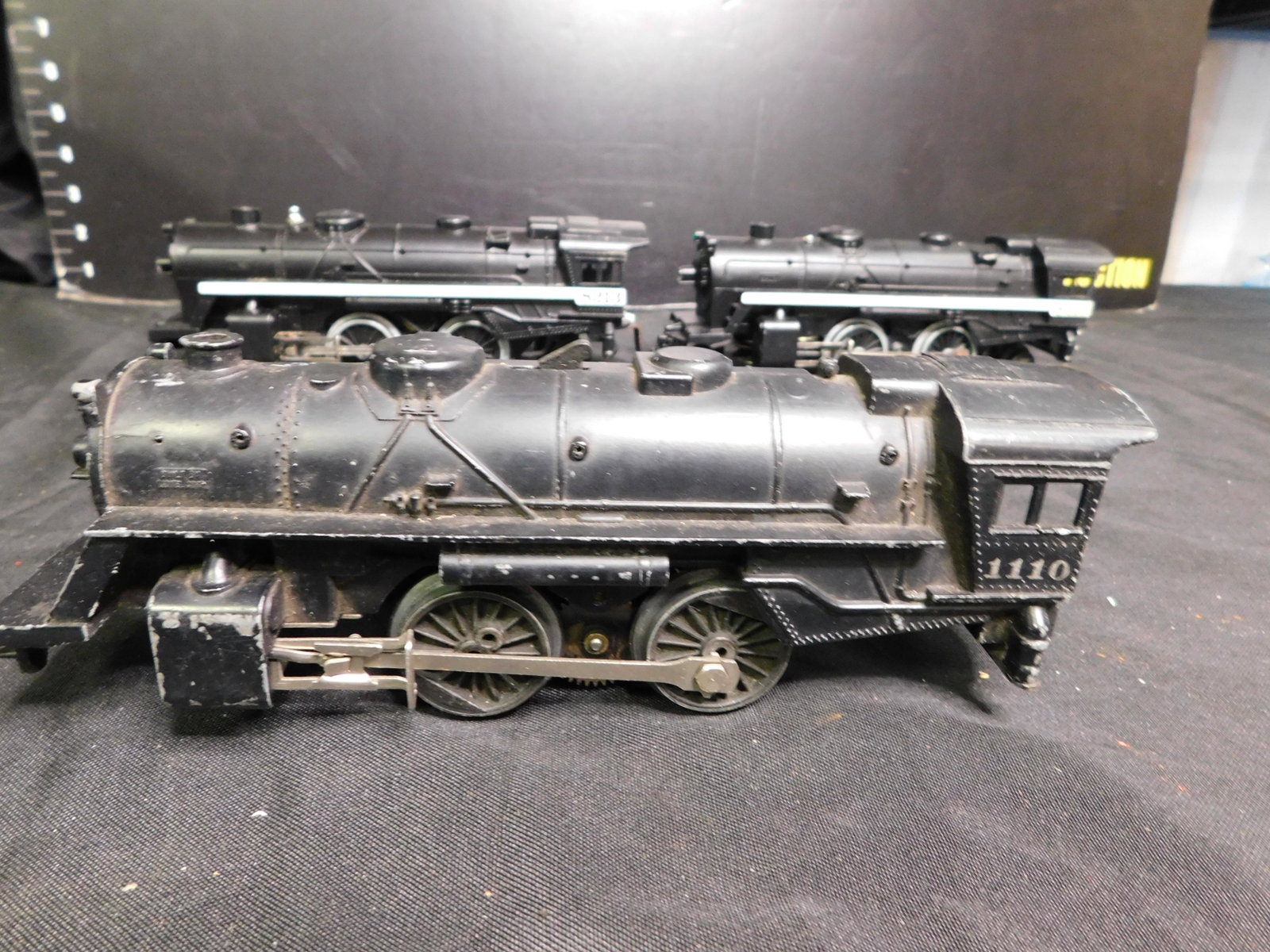 Lot of 3 Lionel Engines: Lot of 3 Lionel Engines. One Lionel Post War Engine - Missing Parts #1110 and 2 Lionel Steam Engines 242 #8213. Corrosion on Back of 2 Engines. You are bidding at a live sale, please read the terms an