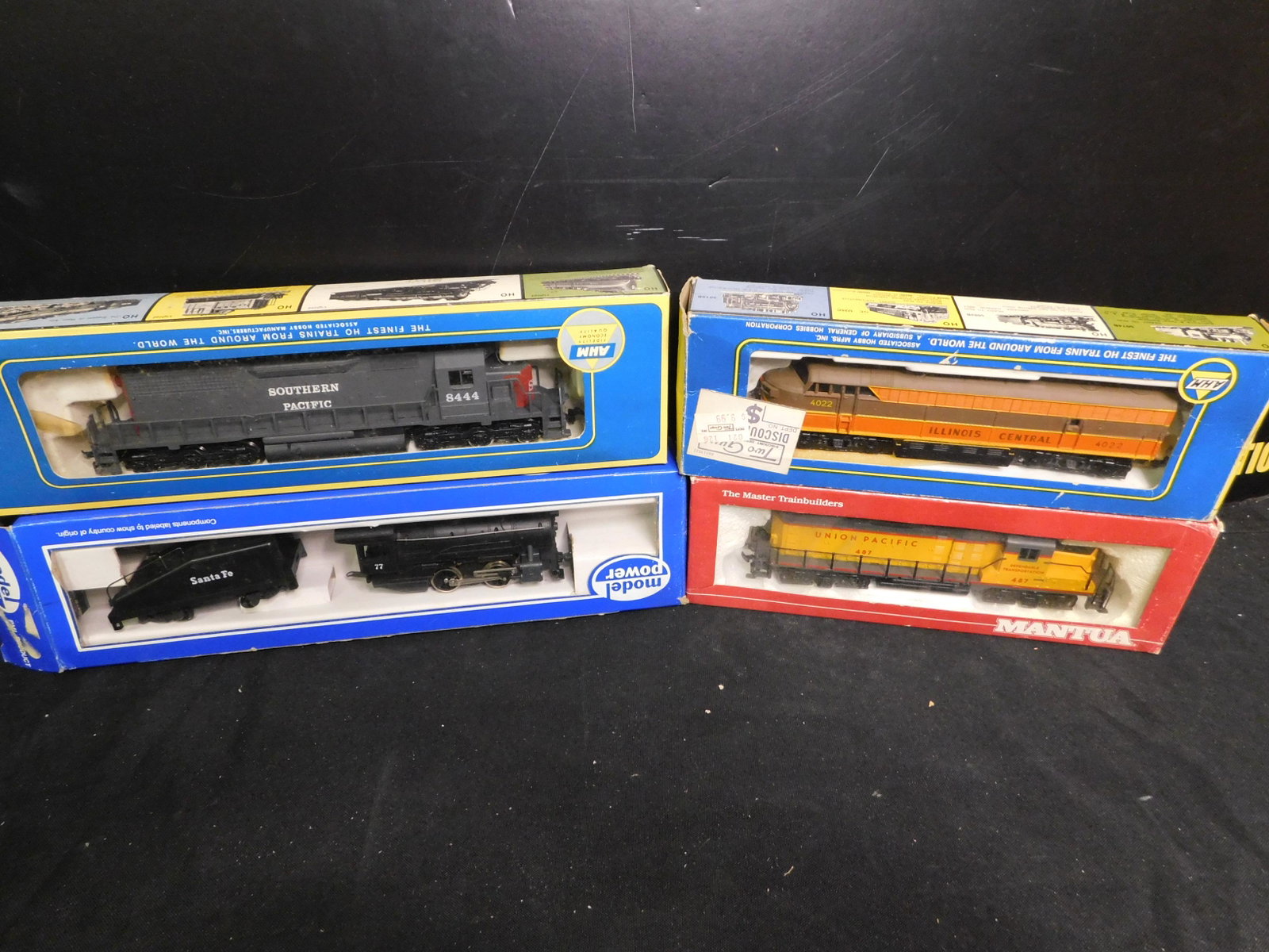 HO Scale Engines - Lot of 4: Lot of 4 HO Scale Engines including Santa Fe 040 Steam Engine, AHM Southern Pacific Diesel, AHM Illinois Central F3 Diesel, Manuta Union Pacific Diesel. You are bidding at a live sale, please read the