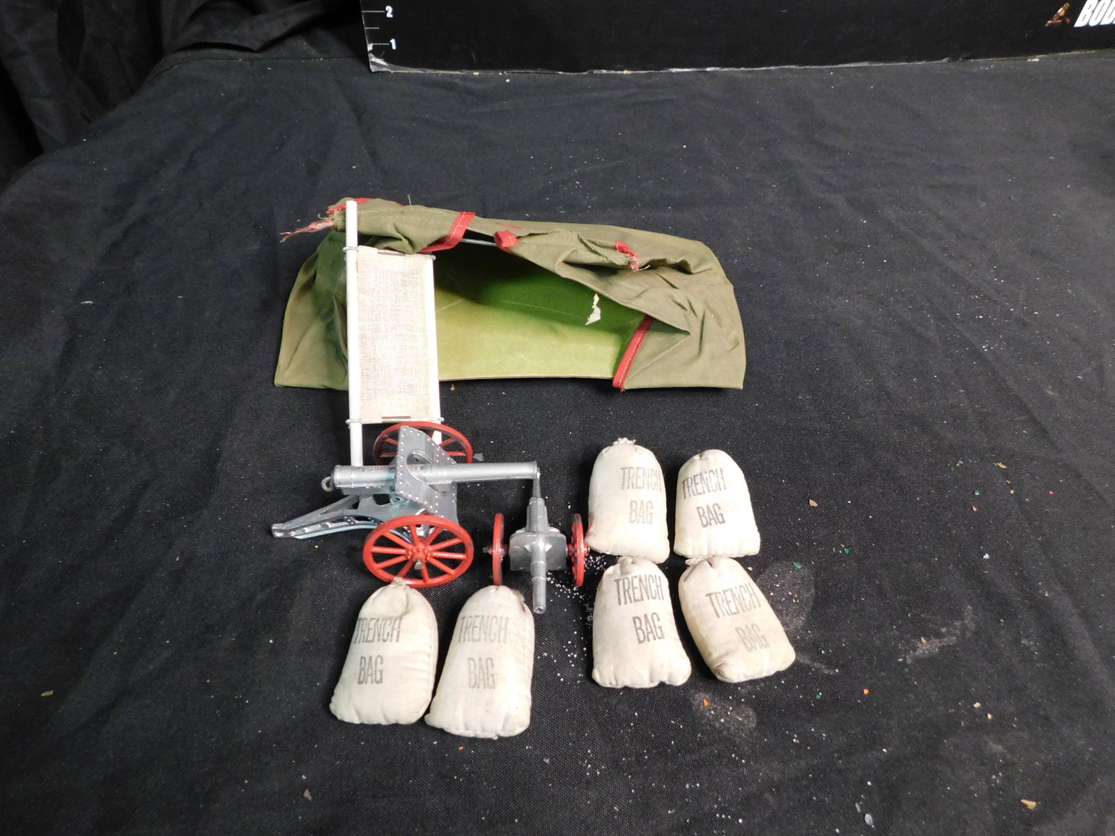Lot of Military Accessories including Cannons and a: Lot of Military Accessories. 2 Die-Cast Cannons, 6 Trench Bags, a Tent and a Cot. You are bidding at a live sale, please read the terms and conditions. We are offering contact-less pick ups at our Sou