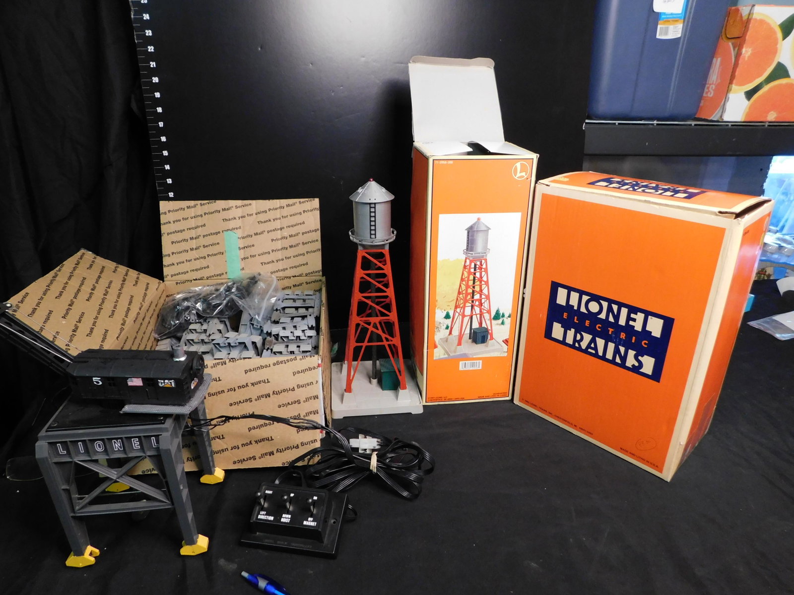 Lionel Mixed Lot of Accessories: Lionel Mixed Lot of Accessories. Lionel Pennsylvania Gantry Crane 12834 Supports Painted Yellow, Lionel Industrial 193 Water Tower 12958, and a Box of Assorted 110 Lionel Trestles - approx 45. You are