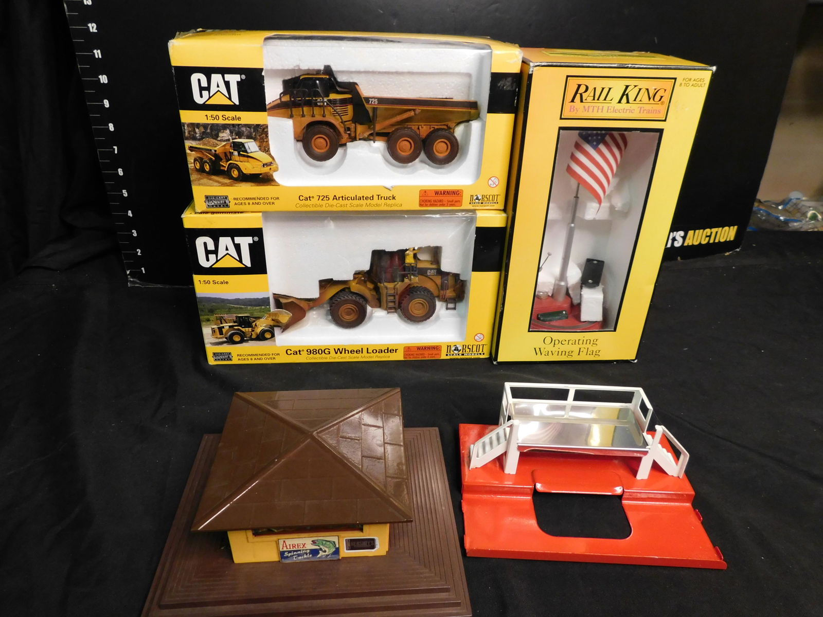 Lot of 5 Train Accessories: Lot of 5 Accessories including Lionel Milk Car Stand - Restored to Red, Lionel News Stand with Whistle, MTH Operating Waving Flag 30-9103, Norscot Caterpillar Wheel Loader Weathered and Norscort Cater