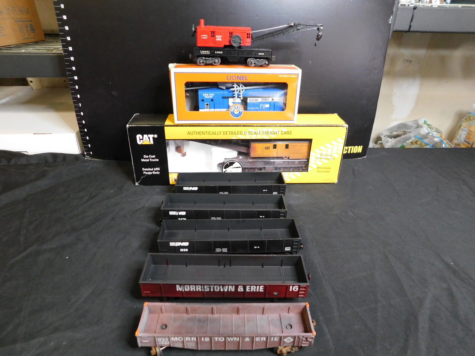 Group Lot of 8 Train Cars including Lionel and MTH: Group Lot of 8 Train Cars including 2 x Lionel Morristown & Erie Gondola - Weathered, 3 Lionel Norfolk Southern Gondola's, Lionel Post-War 6560, Bucyrus Erie Crane Car - Red Cab -New Condition, Lionel