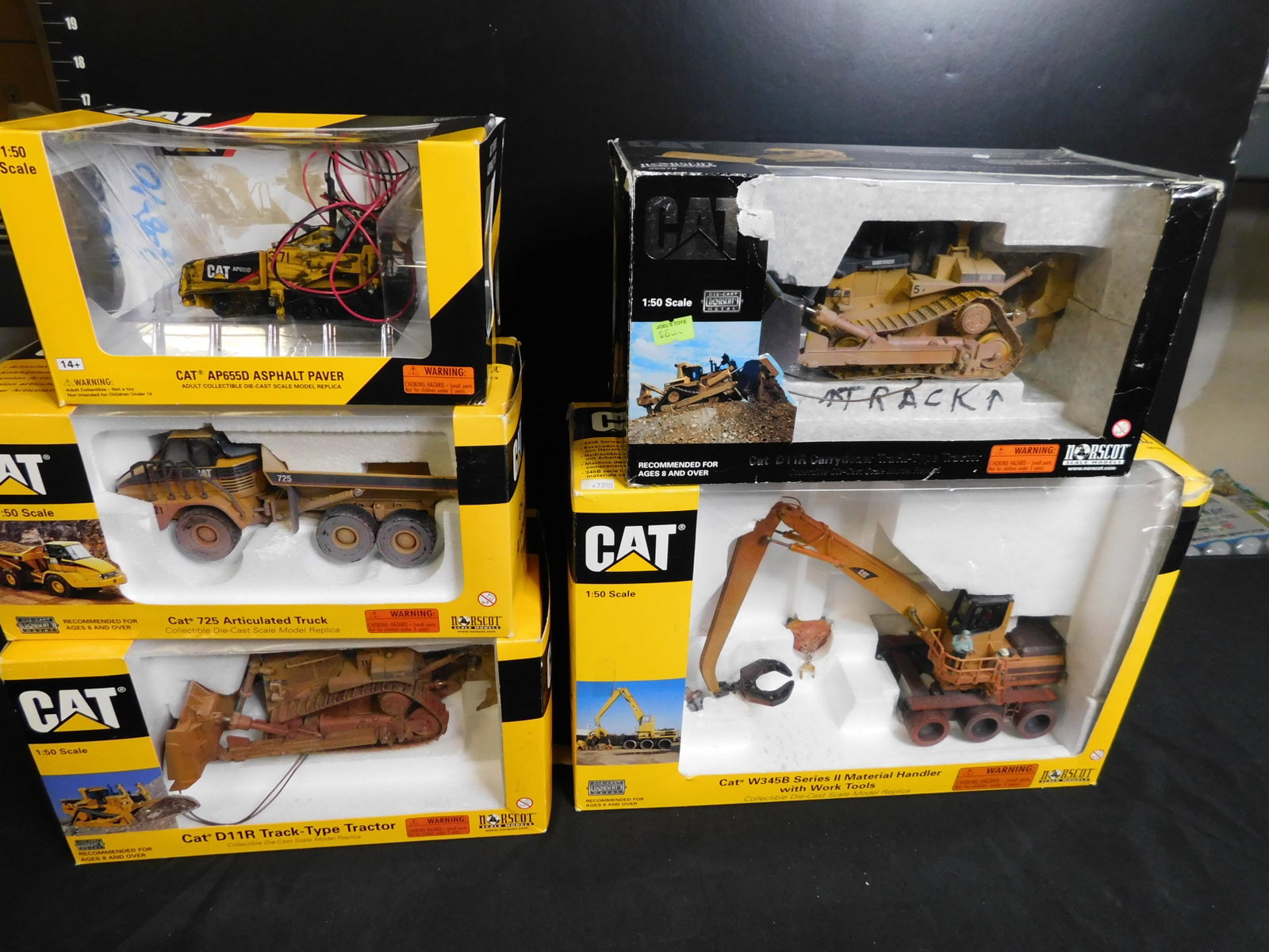 Lot of 5 Norscot Construction Vehicles: Lot of 5 Norscot CAT Construction Vehicles including 725 Articulated Truck, D11R Track Type Tractor, Asphalt Paver, D11R Carry Dozer Track Type Tractor and Series 2 Material Handler with Work Tools an