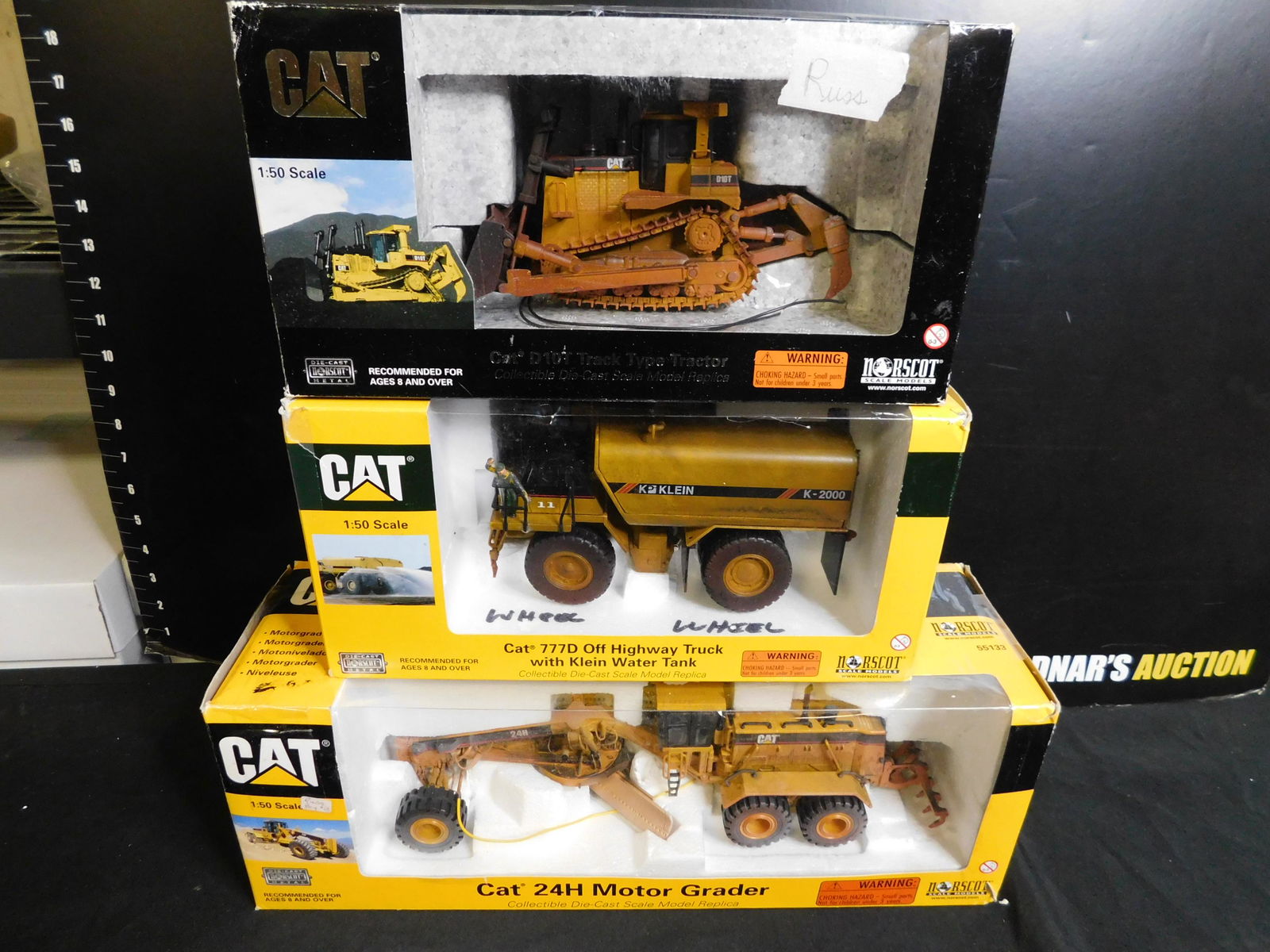 Lot of 3 Norscot CAT Construction Vehicles: Lot of 3 Norscot CAT Construction Vehicles including D10T Track Type Tractor Weathered, Off Highway Truck Klein Water Tank Weathered and 24H Motor Grader Weathered You are bidding at a live sale, plea