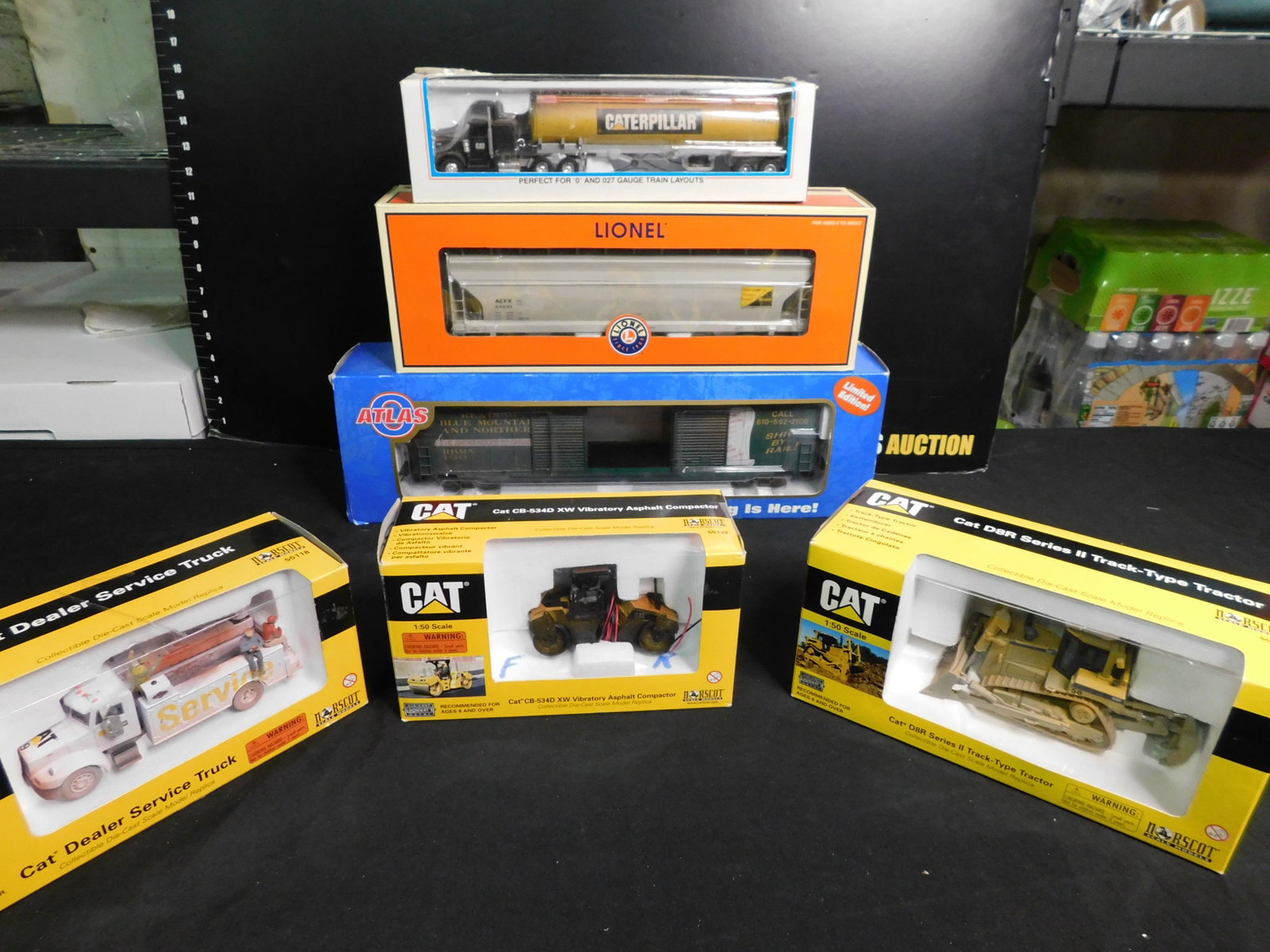Group Lot of 6 Train Cars and Norscott Trucks: Group Lot of 6 Trains and Cars including 3 Norscott CAT Vibrator Asphalt Compactor, Dealer Service Truck, Track Type Tractor, Lionel CAT Tractor 12739 , Lionel Kodak 3 Bay Hopper 27115, Atlas O Ready 