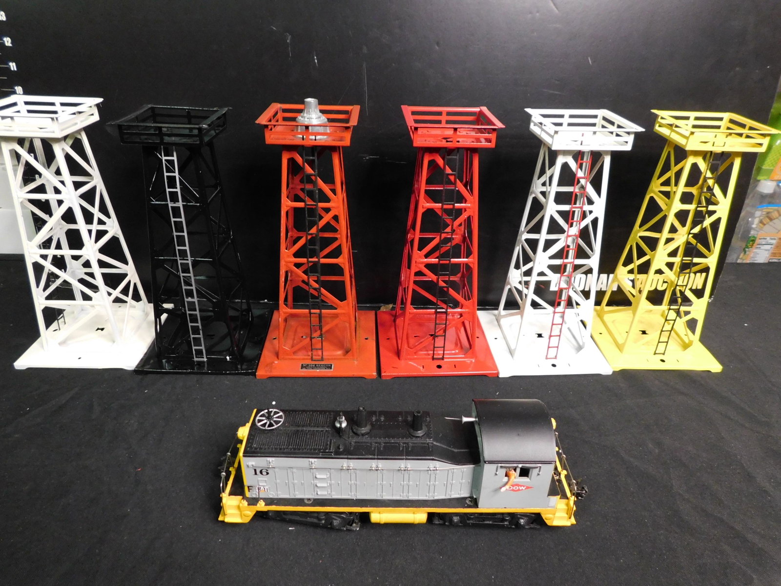 Lionel Diesel Engine and Train Accessories: Lot of 6 Train Accessories and Lionel Diesel Engine. Lionel Post War NW2 Switcher with Metal Trucks Possible Soundboard and Directional Light - Tested and Running. 5 Lionel Towers - Missing internal p