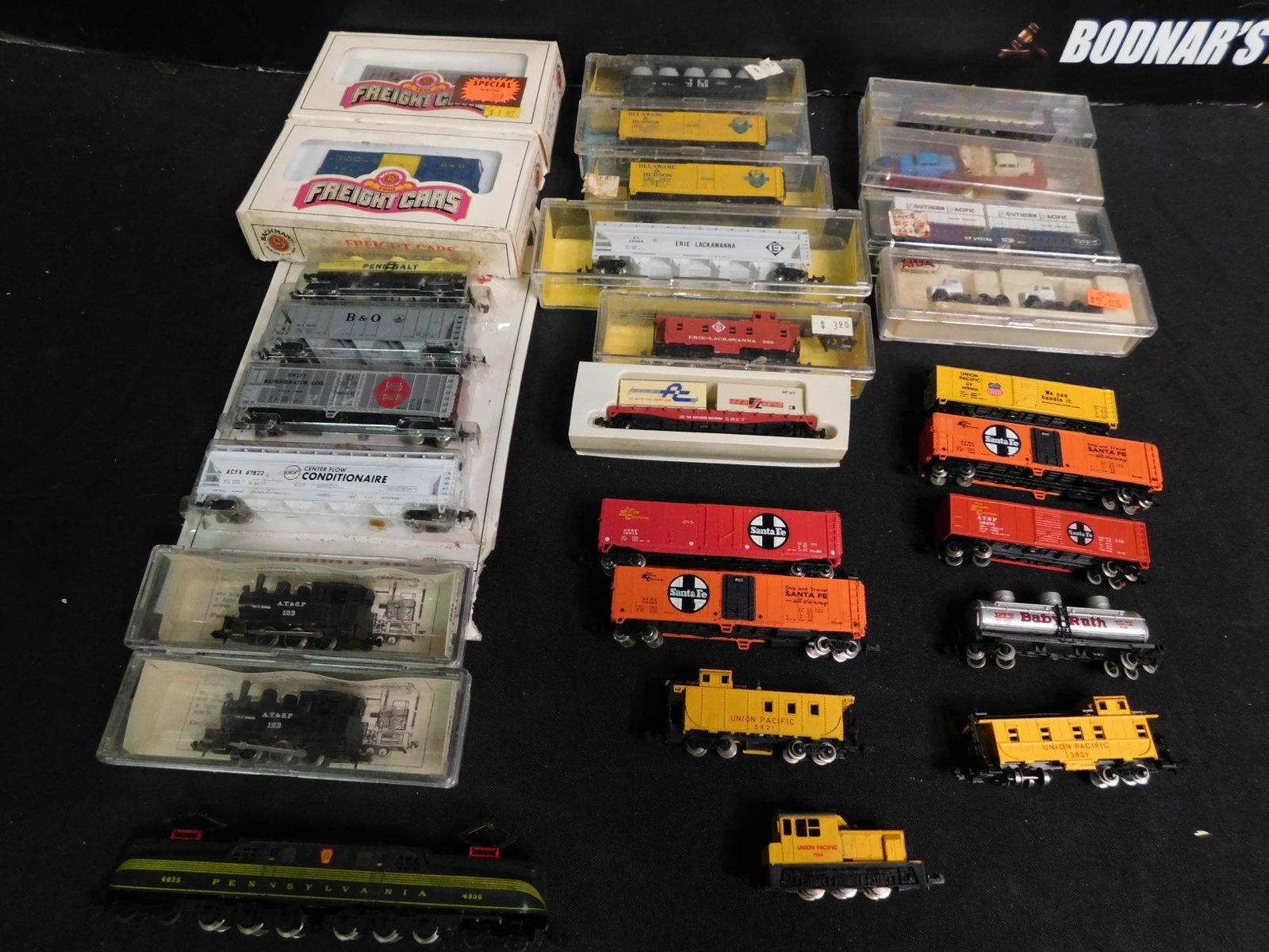 Lot of N Scale Trains including Engines: Lot of 28 N Scale Trains including 2 Steam Engines, 1 Electric GG1, 1 Diesel Switcher, and 24 Rolling Stock. You are bidding at a live sale, please read the terms and conditions. We are offering conta