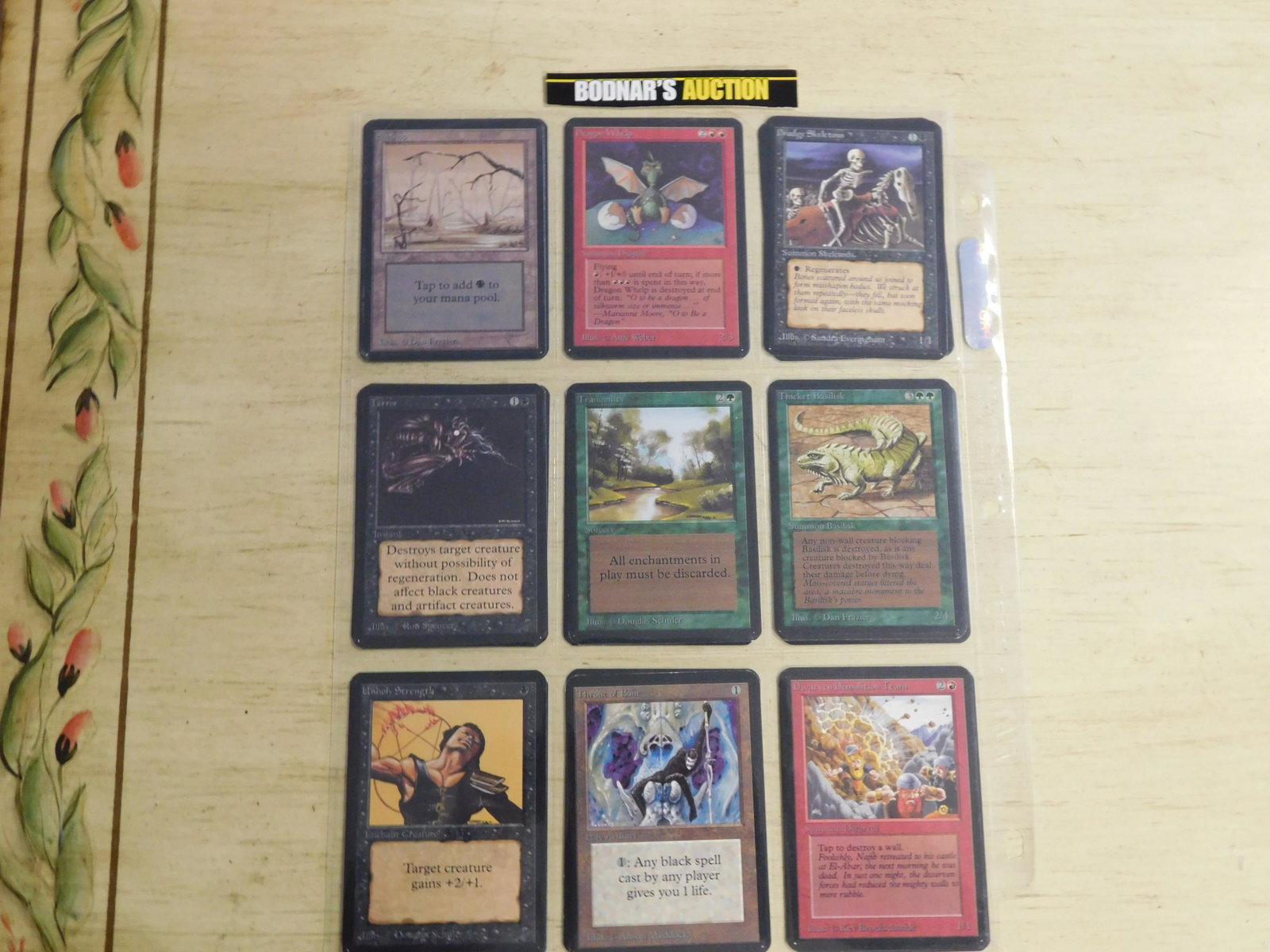 Lot of 9 MTG Alpha Set Cards - 1995: Lot of 9 Magic the Gathering 1993 Alpha Cards. Included in this lot are : Swamp, Dragon Whelp, Drudge Skeletons, Terror, Tranquility, Thicket Basilisk, Unholy Strength, Throne of Bone, and Dwarven Dem