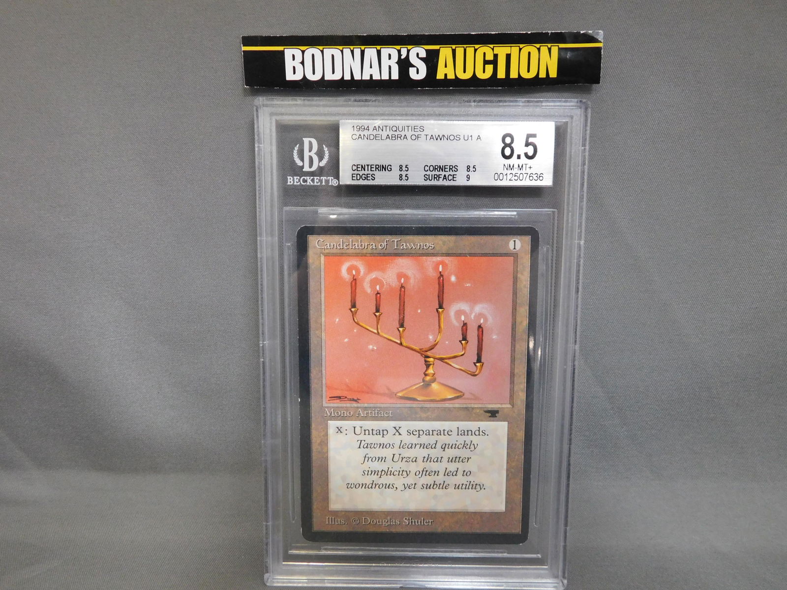 MTG Candelabra of Tawnos 1994 Antiquities - BGS Graded: Magic the Gathering - Candelabra of Tawnos U1 A -Antiquities 1994. Beckett Graded 8.5 NM-MT+. Centering 8.5, Edges 8.5, Corners 8.5 and Surface 9. Serial #0012507636. You are bidding at a live sale, p