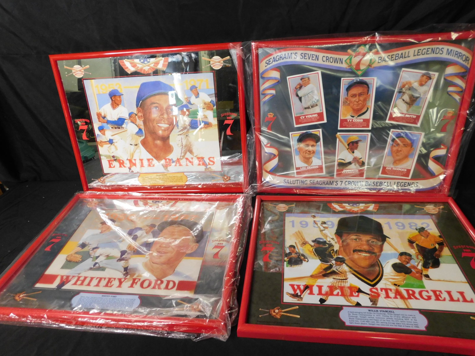 Lot of 4 Seagrams 7 Advertisment Baseball Mirrors and: Lot of 4 Seagrams 7 Baseball Mirrors and Framed Picture. Included in this lot is Ernie Banks, Baseball Legends, and Whitey Ford Framed Mirror. Also included is a Willie Stargell framed poster. This sa