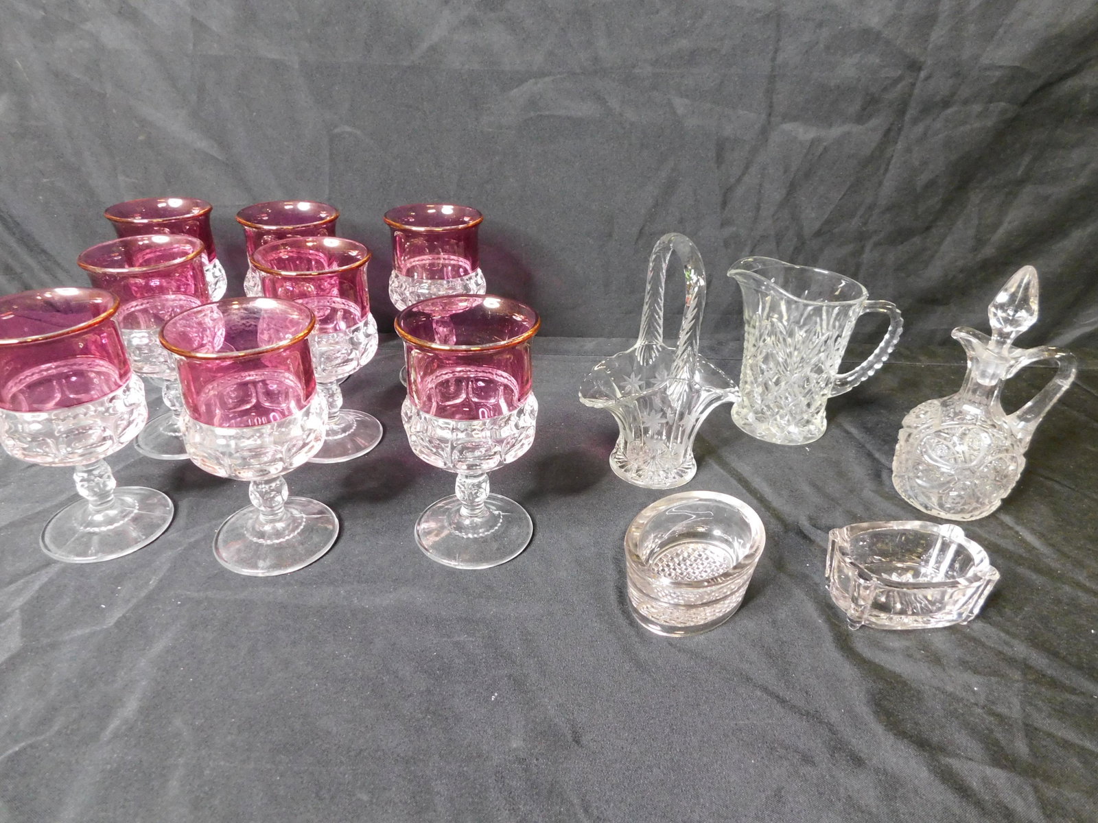Box Lot with Cut Glass and Pressed Glass: Box Lot with Cut Glass and Pressed Glass including Cranberry and Clear Glasses. This sale will be broadcast live on sale day with an auctioneer and caller calling full descriptions of each lot being s