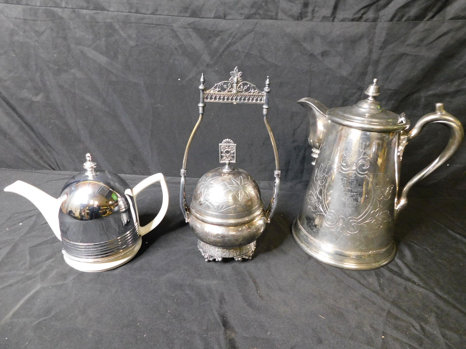 Box Lot of Silverplate and Porcelain: Box Lot of Etched Silverplate and a Porcelain and Stainless Teapot. This sale will be broadcast live on sale day with an auctioneer and caller calling full descriptions of each lot being sold, as well