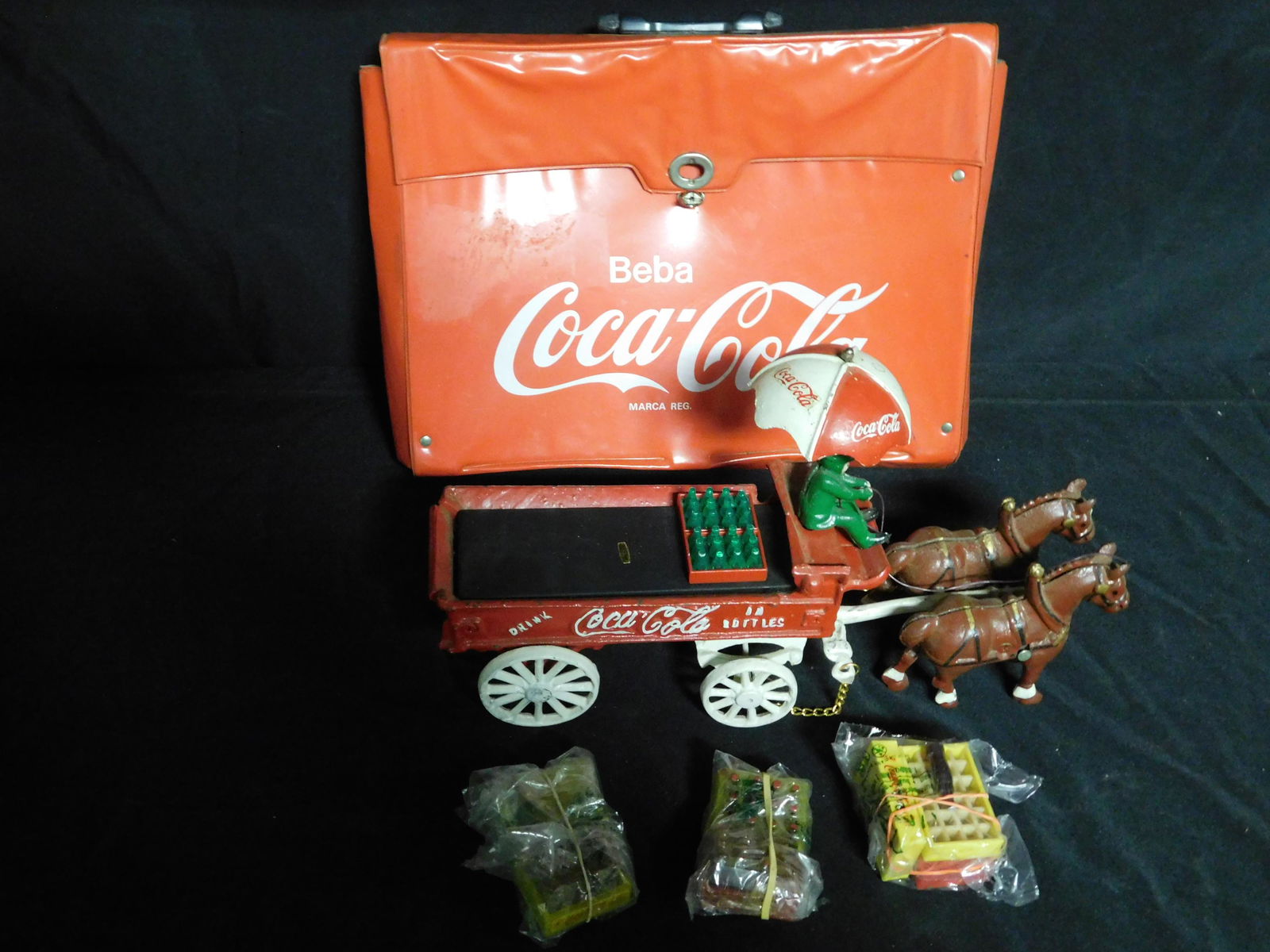 Box Lot of Coca-Cola: Box Lot with Cast Iron Coca Cola Truck and Coca Cola Travel Bag. This sale will be broadcast live on sale day with an auctioneer and caller calling full descriptions of each lot being sold, as well as