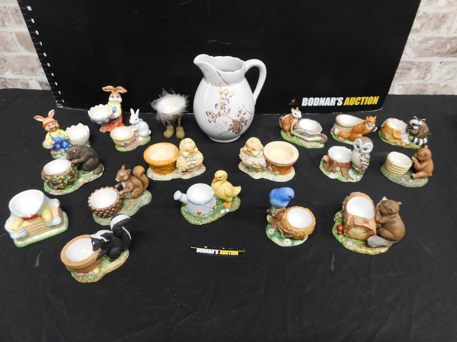 Box Lot of Egg Cups: Box Lot of Egg Cups - Many are from Franklin Mint Forest Friends Collection. This sale will be broadcast live on sale day with an auctioneer and caller calling full descriptions of each lot being sold