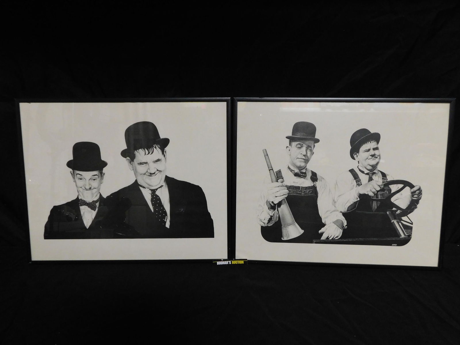 Lot of 2 Laurel and Hardy Prints: Lot of 2 Laurel and Hardy Framed Prints. Measures 20.5" tall x 16.5" wide. This sale will be broadcast live on sale day with an auctioneer and caller calling full descriptions of each lot being sold,