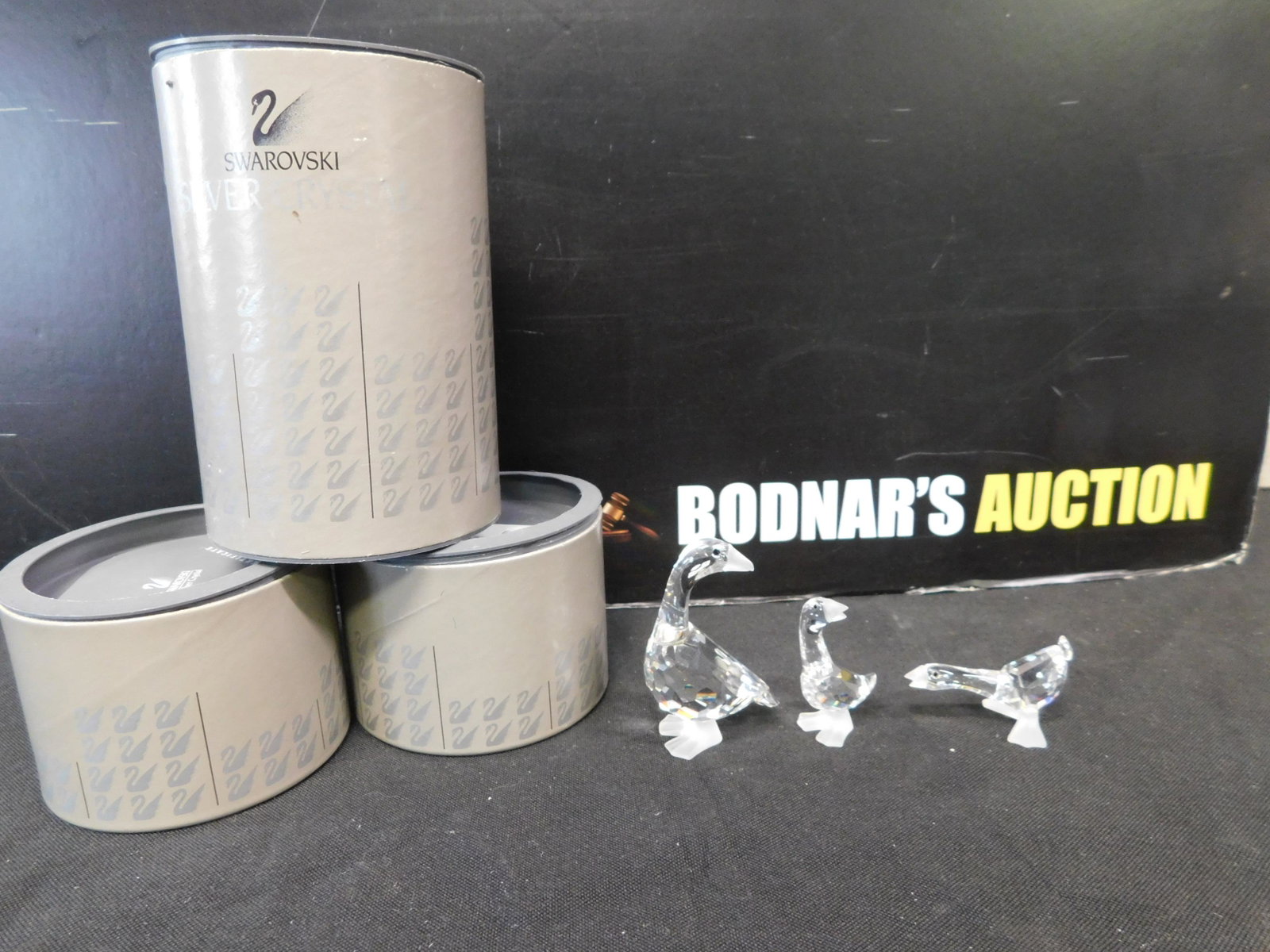 Swarovski Lot of Geese: Swarovski Crystal Lot of Geese including Mother Goose, Harry Gosling and Tom Gosling. Mother Measures 2.5" tall. Harry is in the incorrect box. We are offering contact-less pick ups at our South Bruns