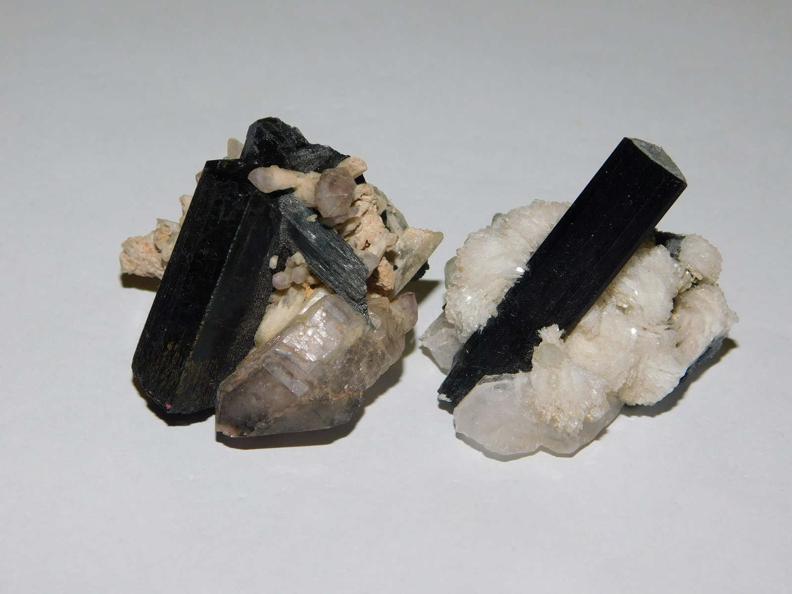 2 Tourmaline with Quartz and Cleavelandite: 2 Tourmaline with quartz and cleavelandite - Africa. Measures approx. 1 1/2". This sale will be broadcast live on sale day with an auctioneer and caller calling full descriptions of each lot being sol