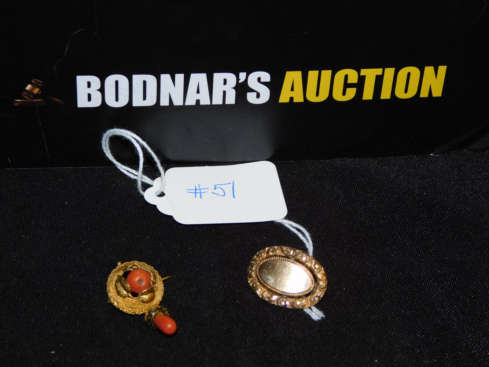 2 Victorian Pins 18K/Coral & Gold Filled: 2 Victorian pins. One set with coral is 18K yellow gold. Measures approx.1 1/4" long and 1" across. The other pin is gold filled. You are bidding at a live sale, please read the terms and conditions.