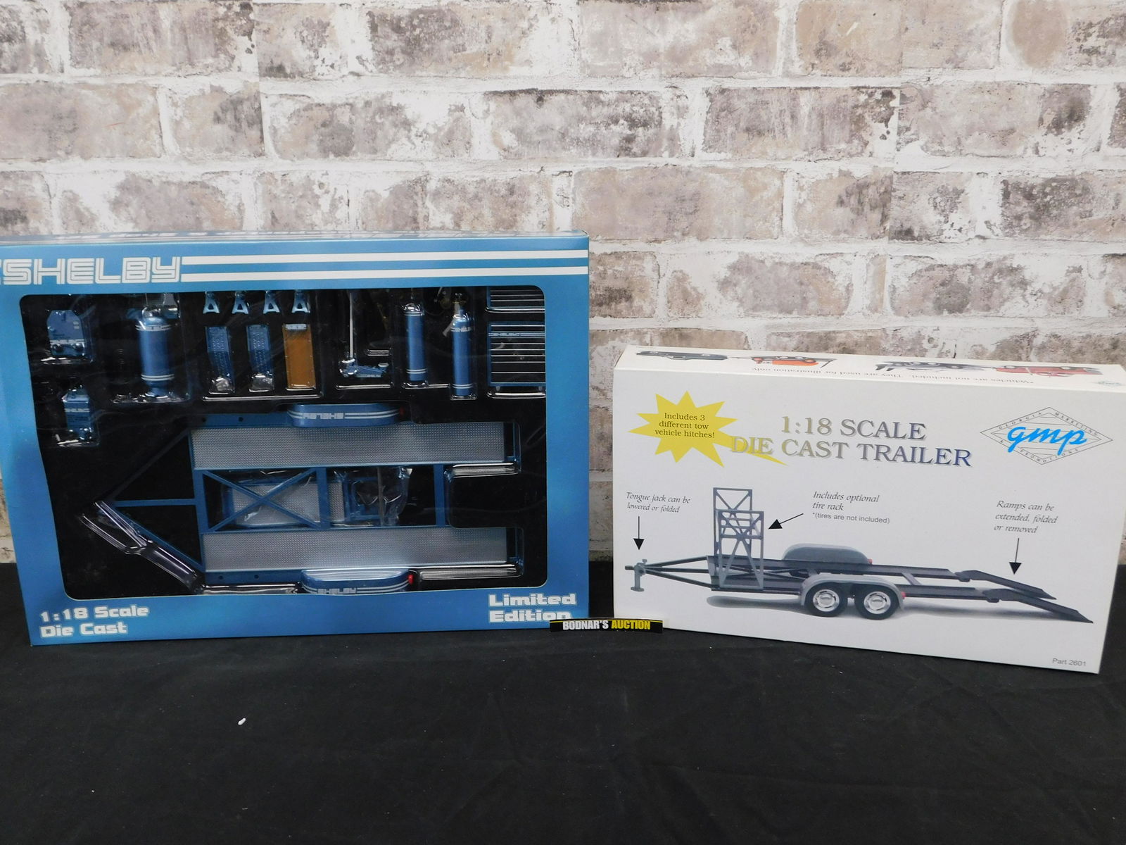 Lot of 2 GMP Accessory Sets including Shelby: Lot of 2 GMP Accessory Sets. Included is a Shelby 1:18 Scale Transporter & Shop Set - Part #2606B and 1:18 Scale Die Cast Trailer. You are bidding at a live sale, please read the terms and conditions.
