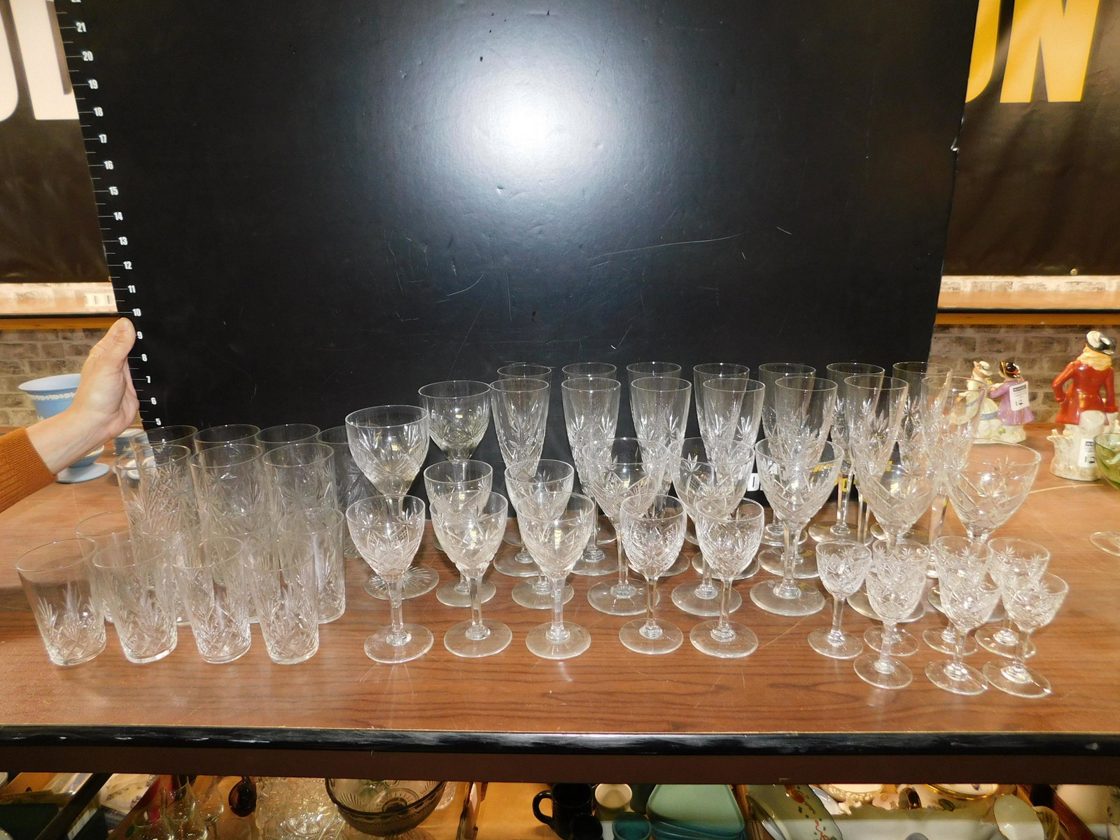 Lot of 50 Cut Crystal Glasses: Lot of 50 Cut Crystal Glasses including 14 Champagne Flutes, 12 Wine Glasses in Assorted Sizes, 7 Cordial Glasses, 7 Water Tumblers, and 8 Juice Glasses. Some have flea bite chips on the edges. This s