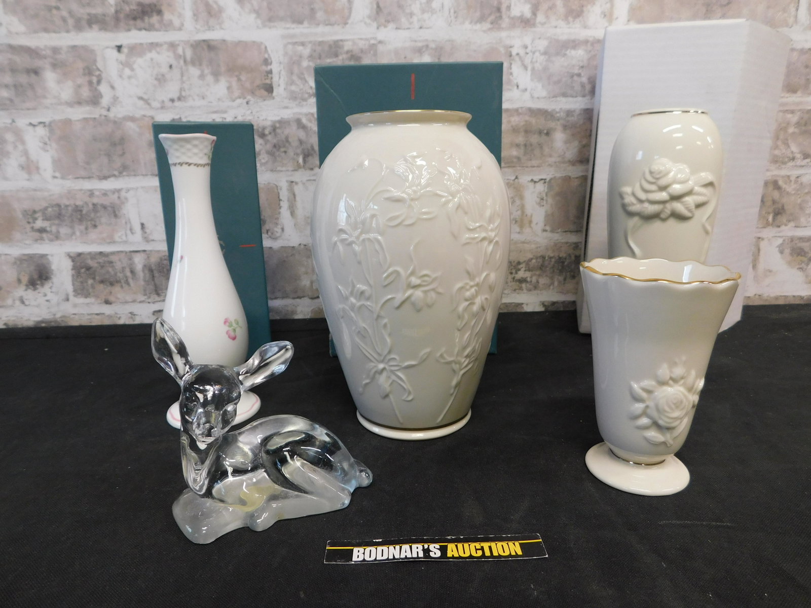 Lot of Lenox and Fenton: Lot of Lenox and Fenton. Included are 4 Lenox Vases and 1 Fenton Deer. Vases measure 4"-7.5" tall. Deer measures 3.5" tall. This sale will be broadcast live on sale day with an auctioneer and caller c