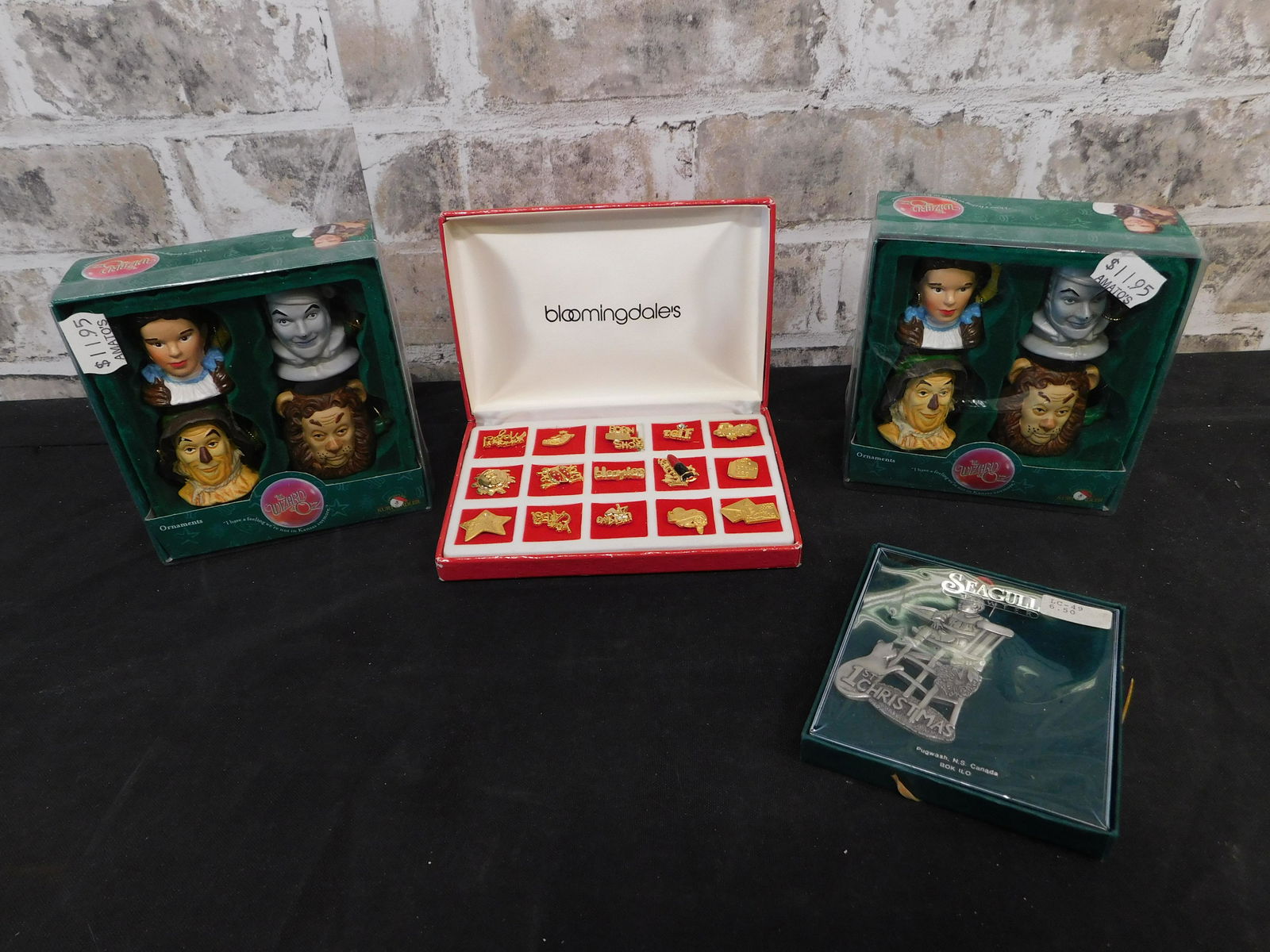 Lot including Wizard of Oz Ornaments and Bloomingdale: Lot of Wizard of Oz Ornaments, Bloomingdale Pins, and Seagull Ornament. This sale will be broadcast live on sale day with an auctioneer and caller calling full descriptions of each lot being sold, as