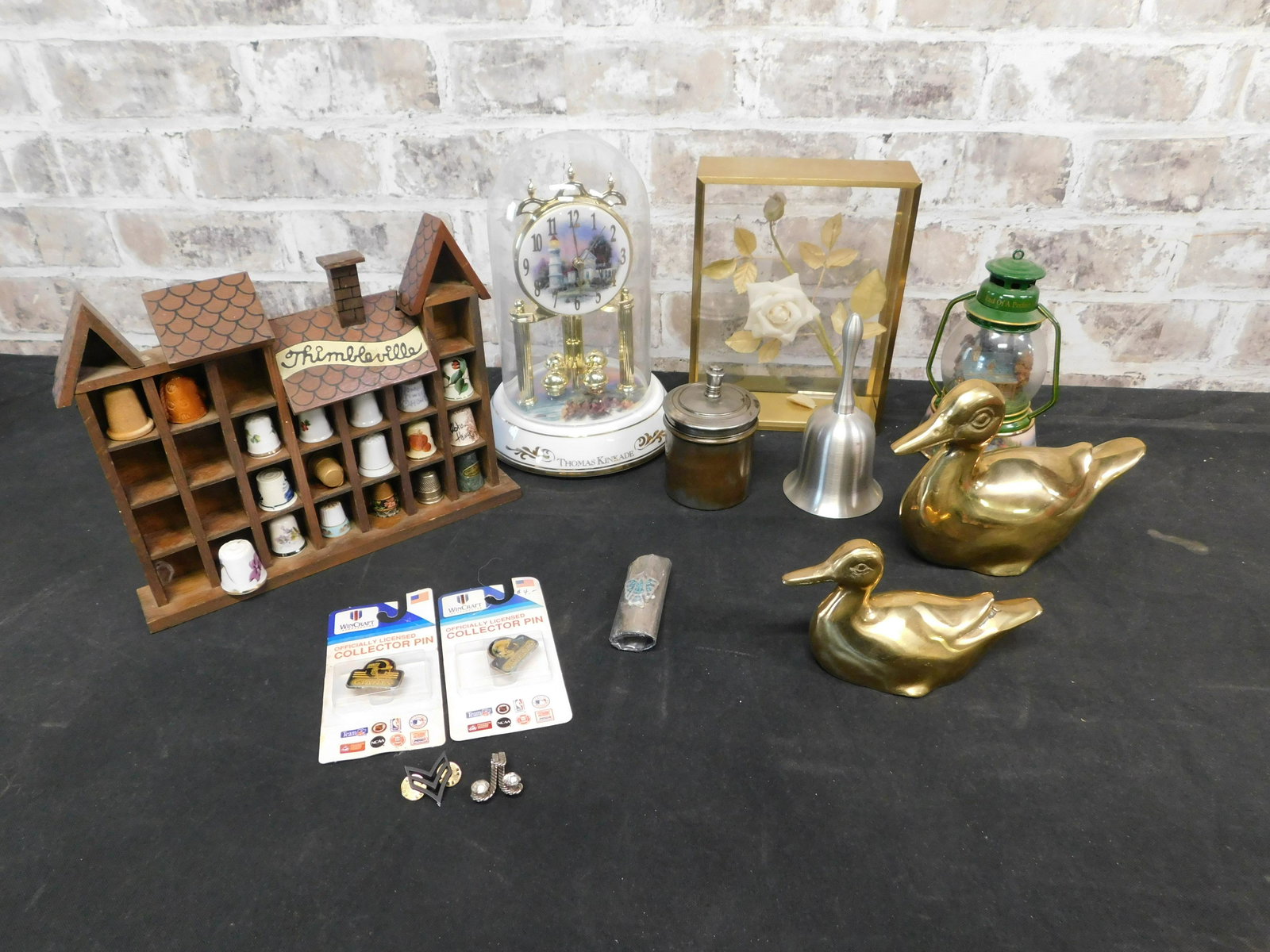 Box Lot with Thomas Kinkaid Anniversary Clock and: Box Lot with Thomas Kinkaid Anniversary Clock, Thimble Collection, Brass Ducks, and More. This sale will be broadcast live on sale day with an auctioneer and caller calling full descriptions of each l