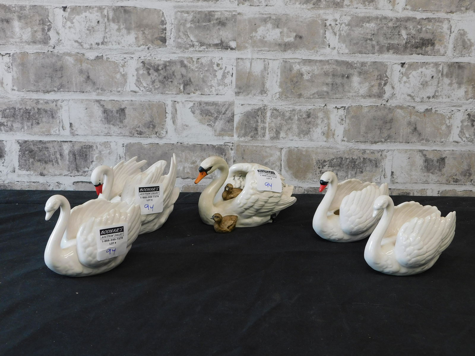 Group Lot of 5 Goebel Swan Figurines: Group Lot of 5 Goebel Swan Figurines and Candlesticks. All measure 4" tall and the longest is 7".This sale will be broadcast live on sale day with an auctioneer and caller calling full descriptions of