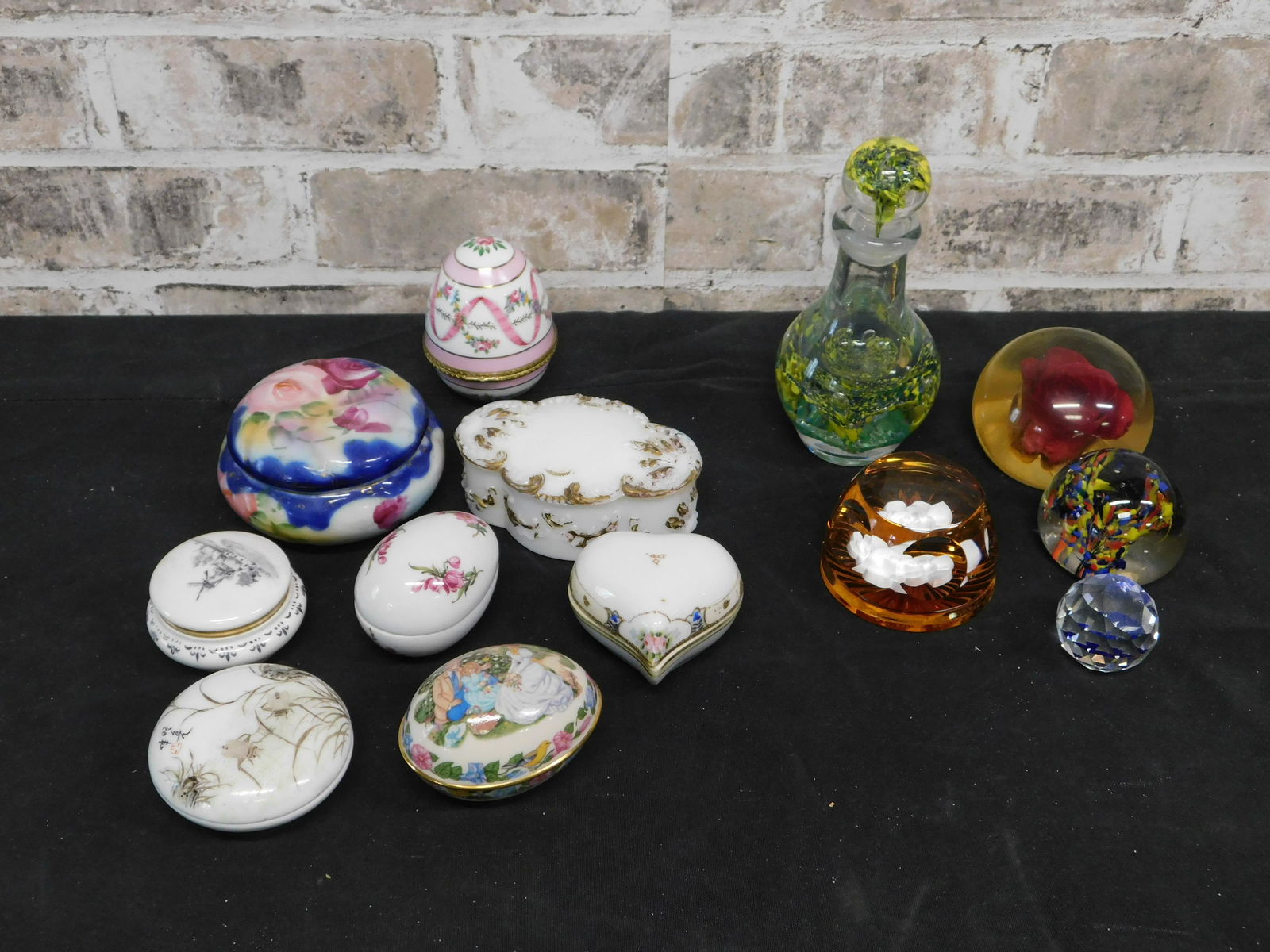 Group Lot of Art Glass Paperweights and Porcelain: Group Lot of Art Glass Paperweights and Porcelain Dresser Boxes. This sale will be broadcast live on sale day with an auctioneer and caller calling full descriptions of each lot being sold, as well as