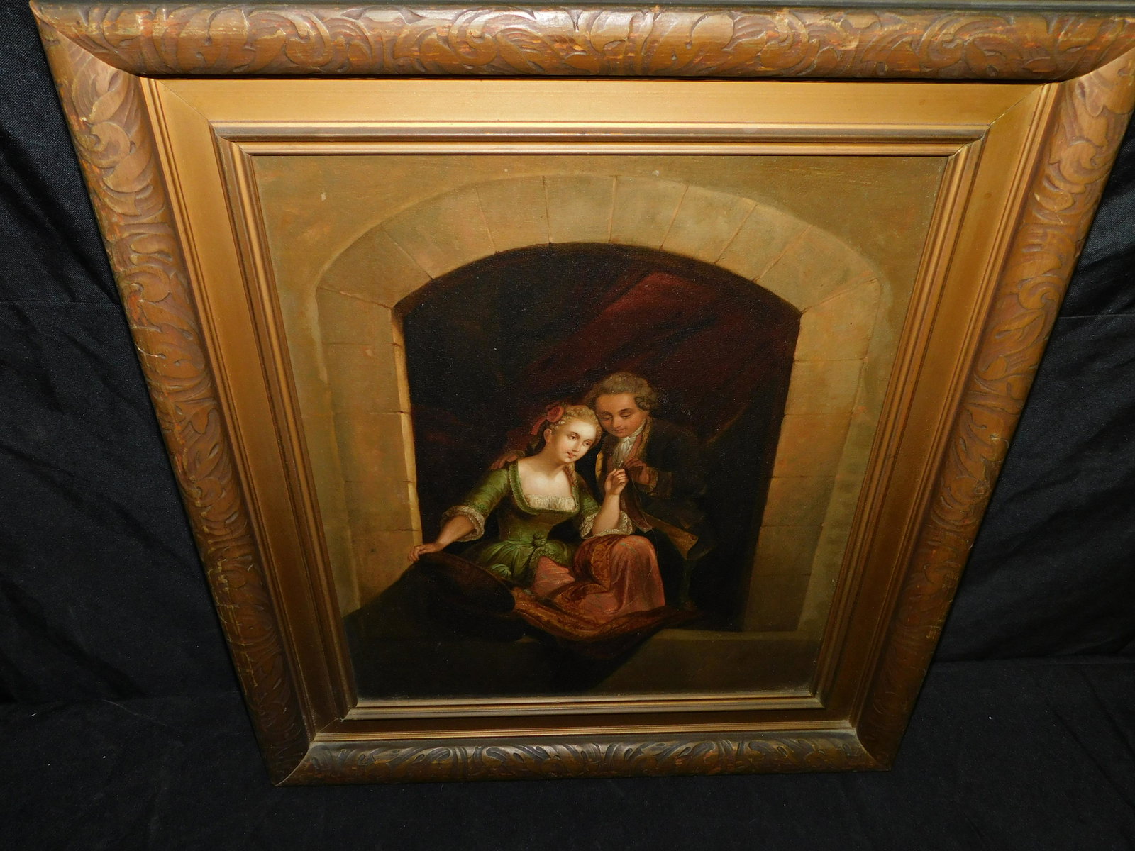 Oil on Board of a Romantic Scene: Turn of the Century Oil on Board depicting a Romantic Scene. Measures 24" tall x 20" wide. You are bidding at a live sale, please read the terms and conditions. We are offering contact-less pick ups a