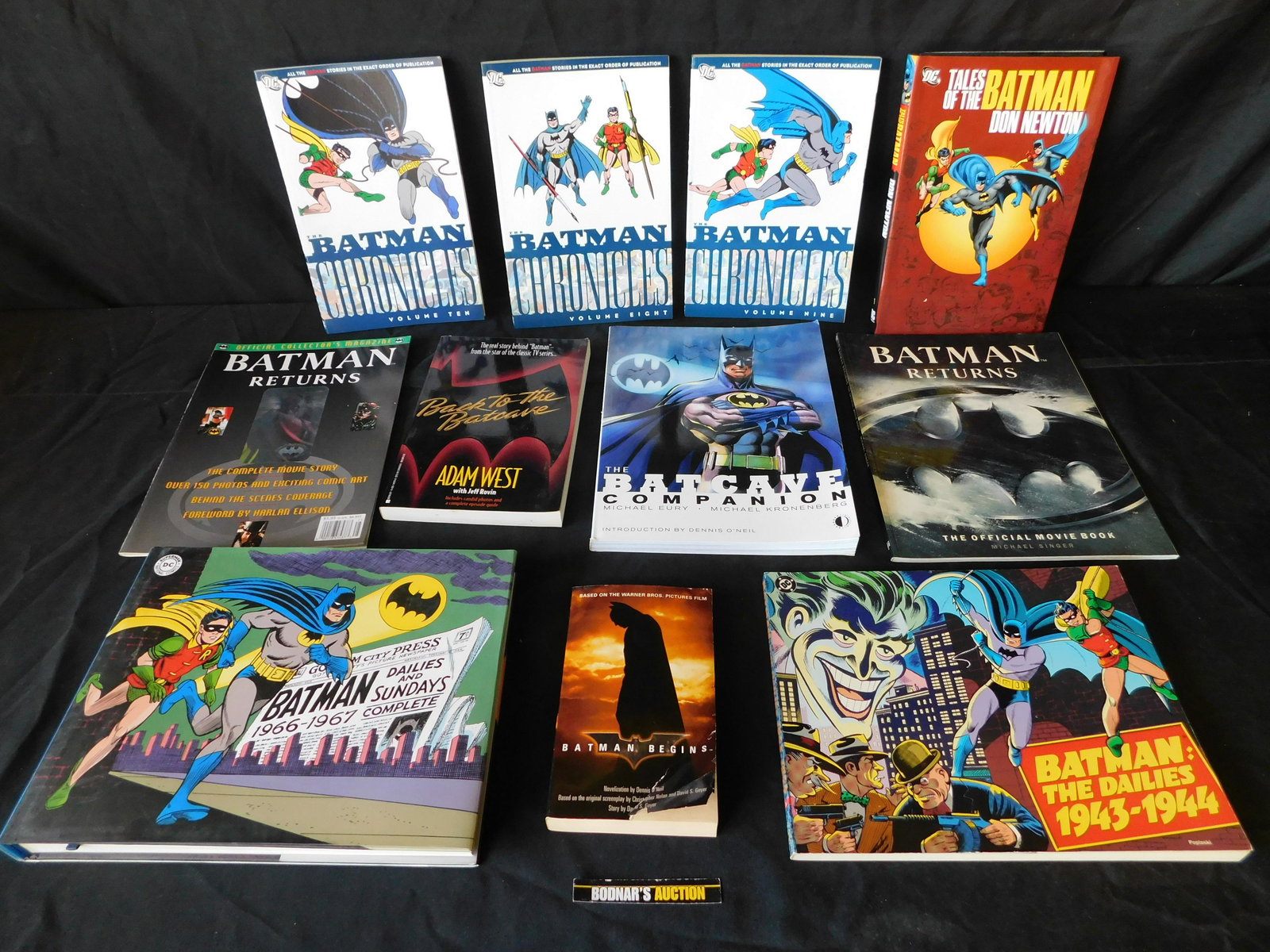 Large Lot of Batman Hardcovers and Softcover Books: Large Lot of Batman Hardcovers and Softcover Books. Included in this lot are Chronicles, and Dailies. The Dailies has some wear to the top edge. This sale will be broadcast live on sale day with an au