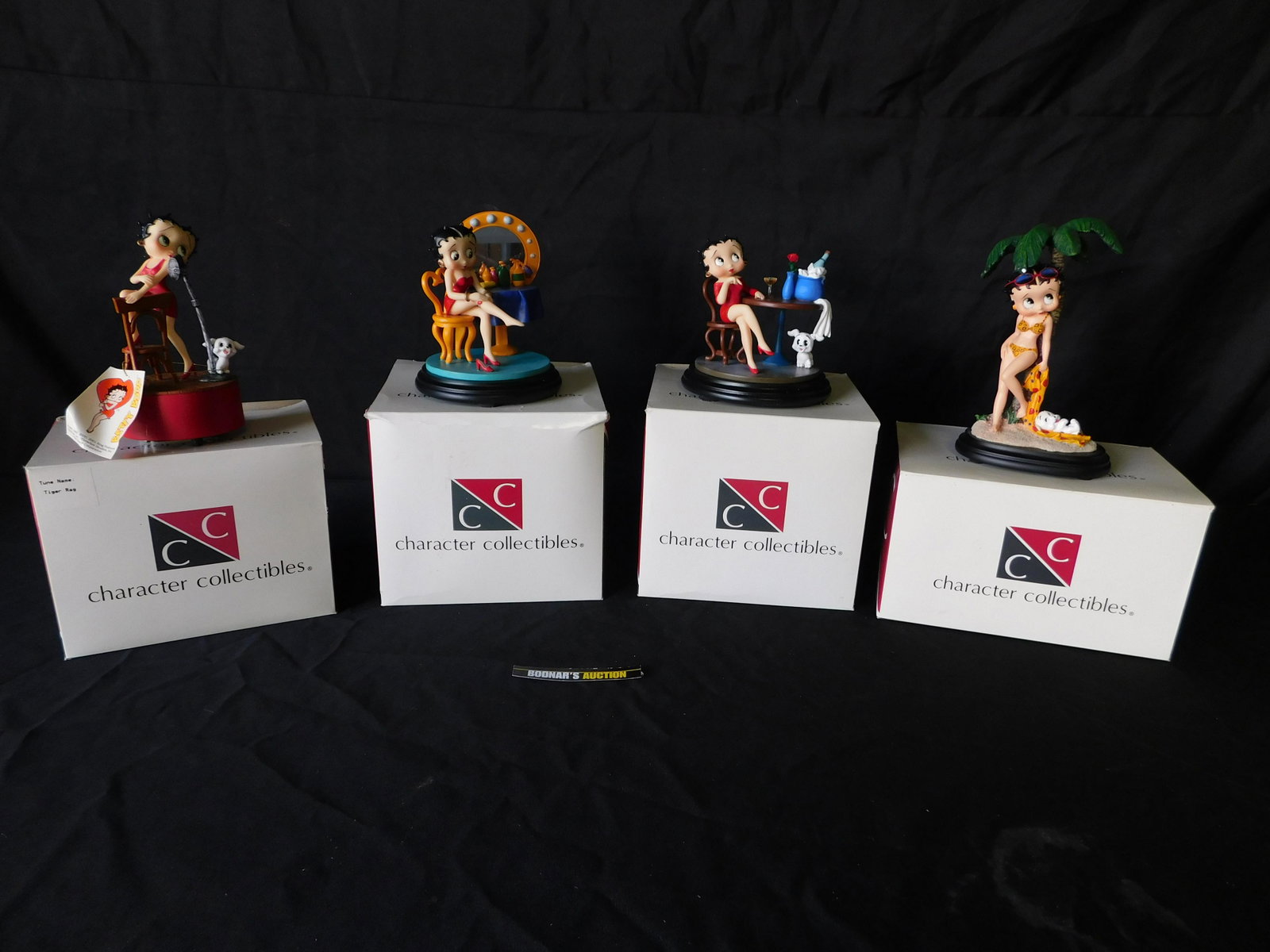 Lot of 4 Character Collectibles Betty Boop Figurines: Lot of 4 Character Collectibles Betty Boop Figures including 1 Music Box. This sale will be broadcast live on sale day with an auctioneer and caller calling full descriptions of each lot being sold, a