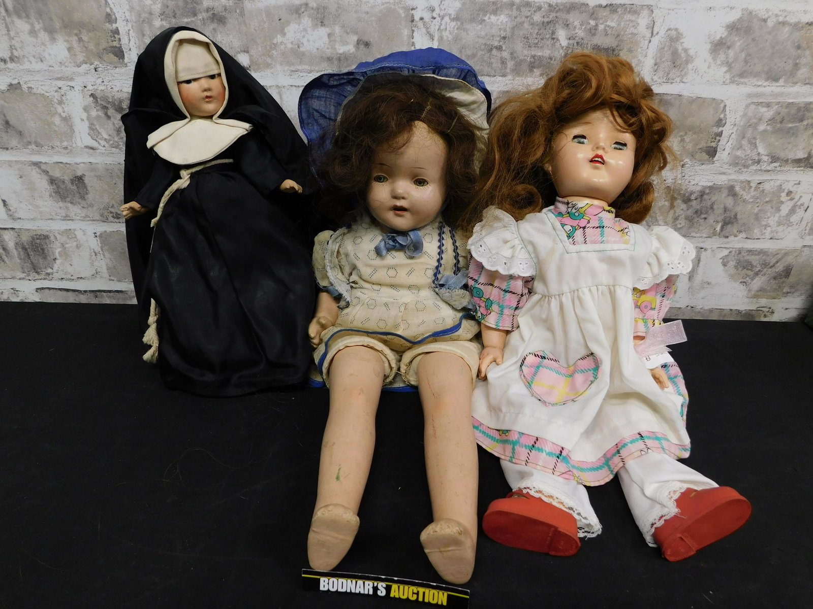 Lot of 3 Composition Dolls: Lot of 3 Composition Dolls. 2 Have Sleepy Eyes and 2 Have showing Teeth. One is a Nun. Some craze to the composition and 1 has some loss to eye color. This sale is an in-house shipping sale on most it