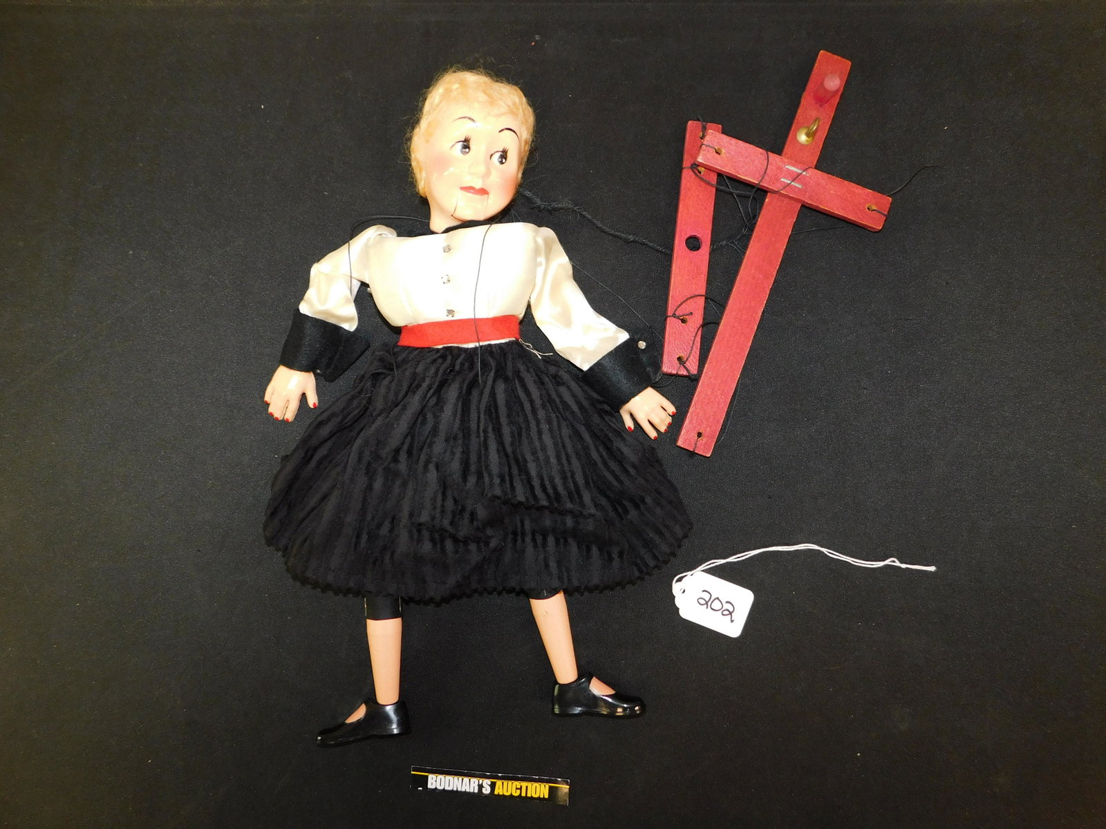 Vintage Marionette with Plastic Face, Hands, and Shoes: Vintage Marionette - Plastic Face, Hands, and Shoes. Wooden Body and Legs. Head has small crack in the neck area. This sale is an in-house shipping sale on most items with a $10.00 per lot packing/han