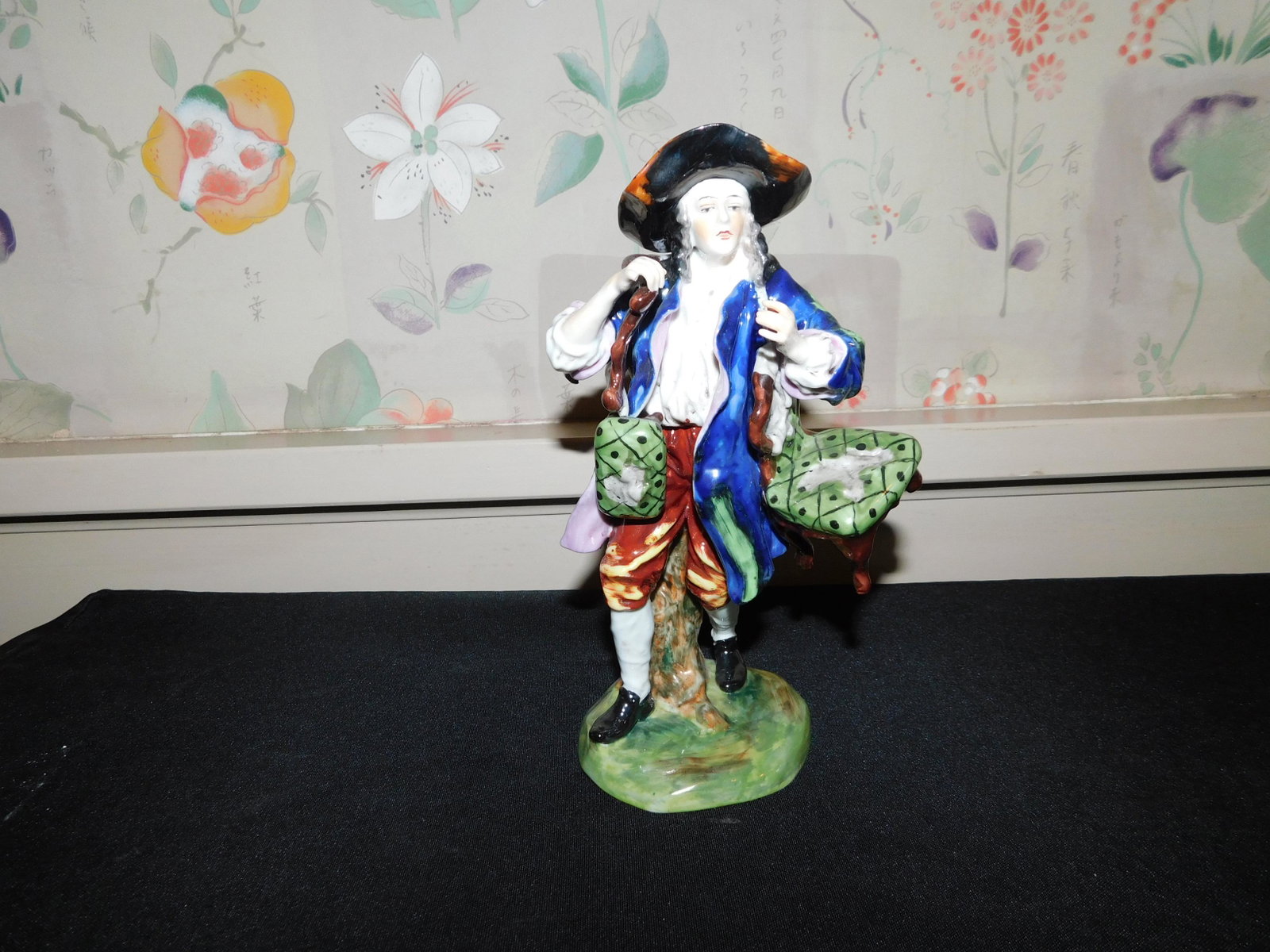 Capodimonte Hand Painted Porcelain Figurine: Capodimonte Hand Painted Porcelain Figurine. Man Carrying Chair. Measures 8" tall. This sale is an in-house shipping sale on most items with a $10.00 per lot packing/handling fee. Please read the Comp