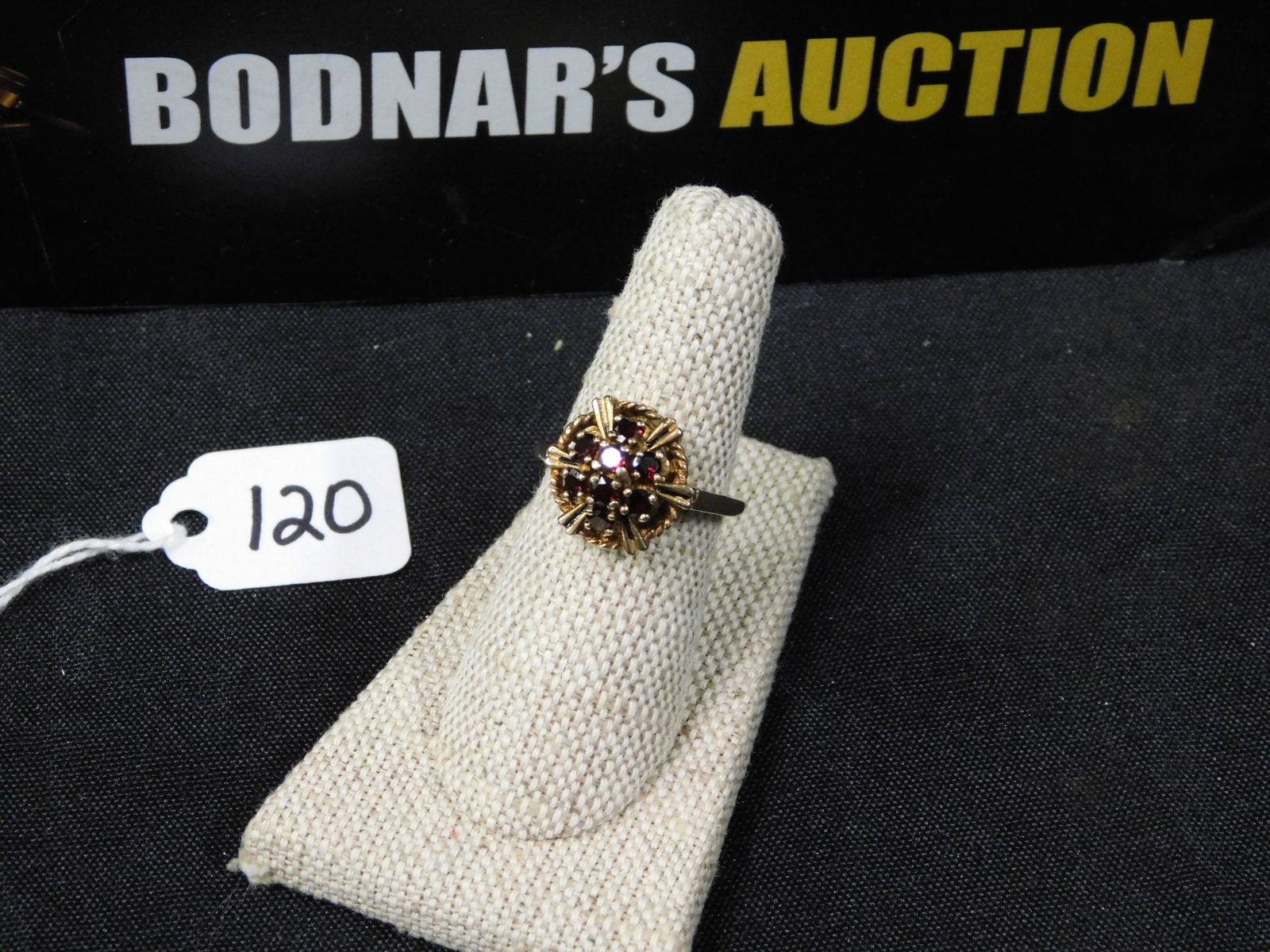 10K & Garnet Women's Ring: 10K and garnet women's ring. Marked. Size 7. All invoices must be paid within 24 hours of the sale. All items are shipped USPS and will be billed separately. A $10 handling fee is added per item. Loca