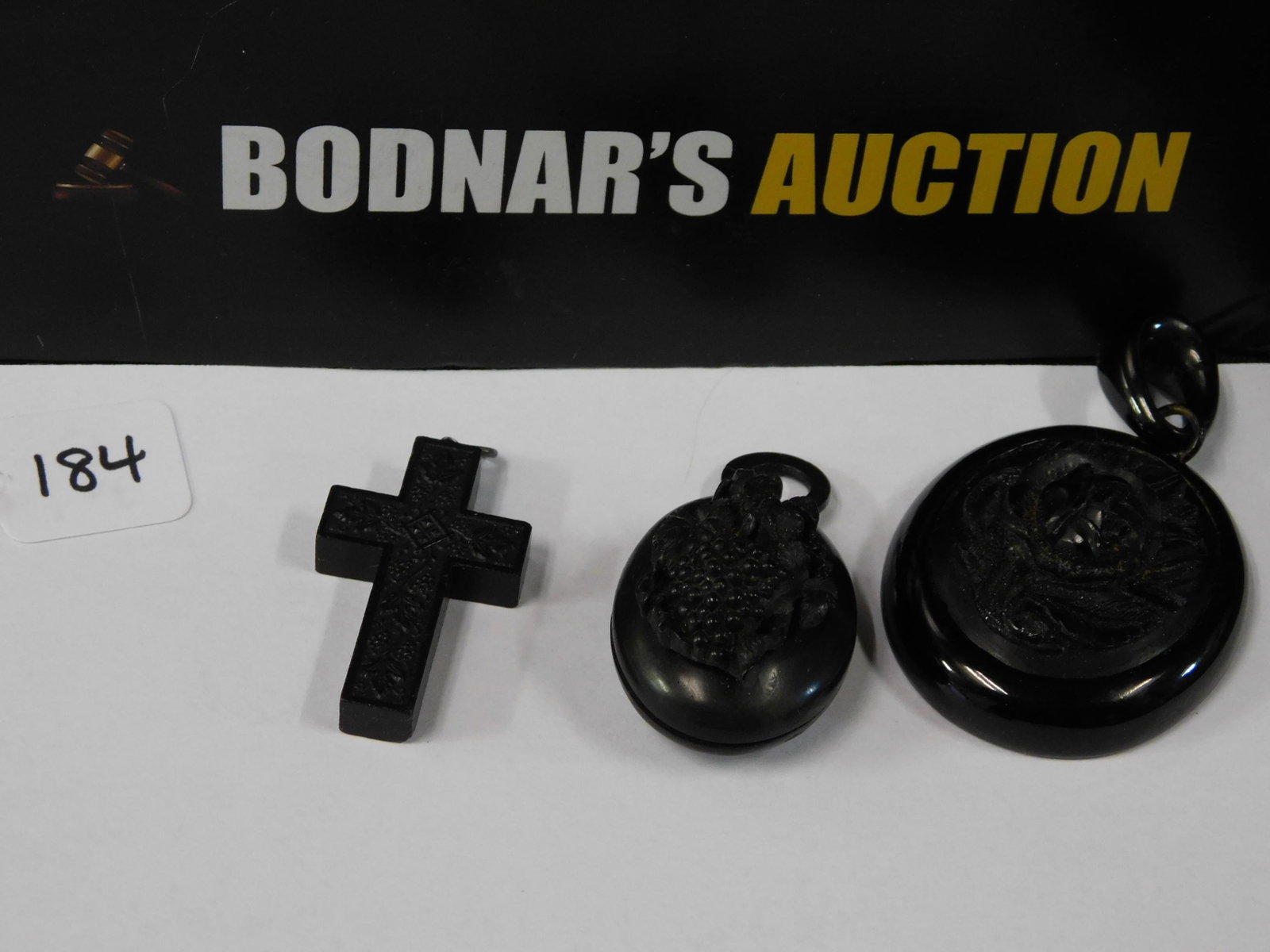 Lot of Mourning Jewelry: Lot of 3 pieces of mourning jewelry including a gutta purcha cross (measures approx. 1 1/2" long), a gutta purcha locket with a lock of hair encased inside (measures approx. 2" long) and a gutta purch