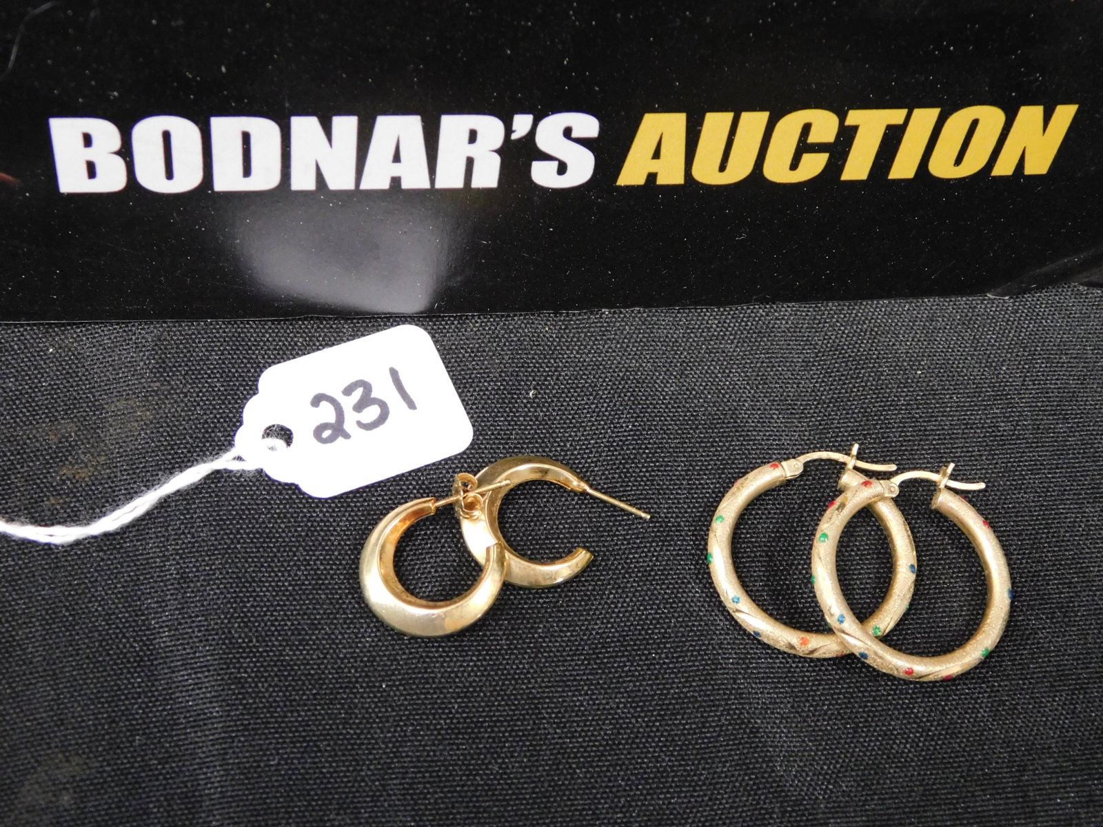 2 Pairs of 14K Hoop Earrings: 2 pairs of 14K hoop earrings. Both marked. One is missing an earring back. Measures approx. 1/2" - 1 1/4". All invoices must be paid within 24 hours of the sale. All items are shipped USPS and will be