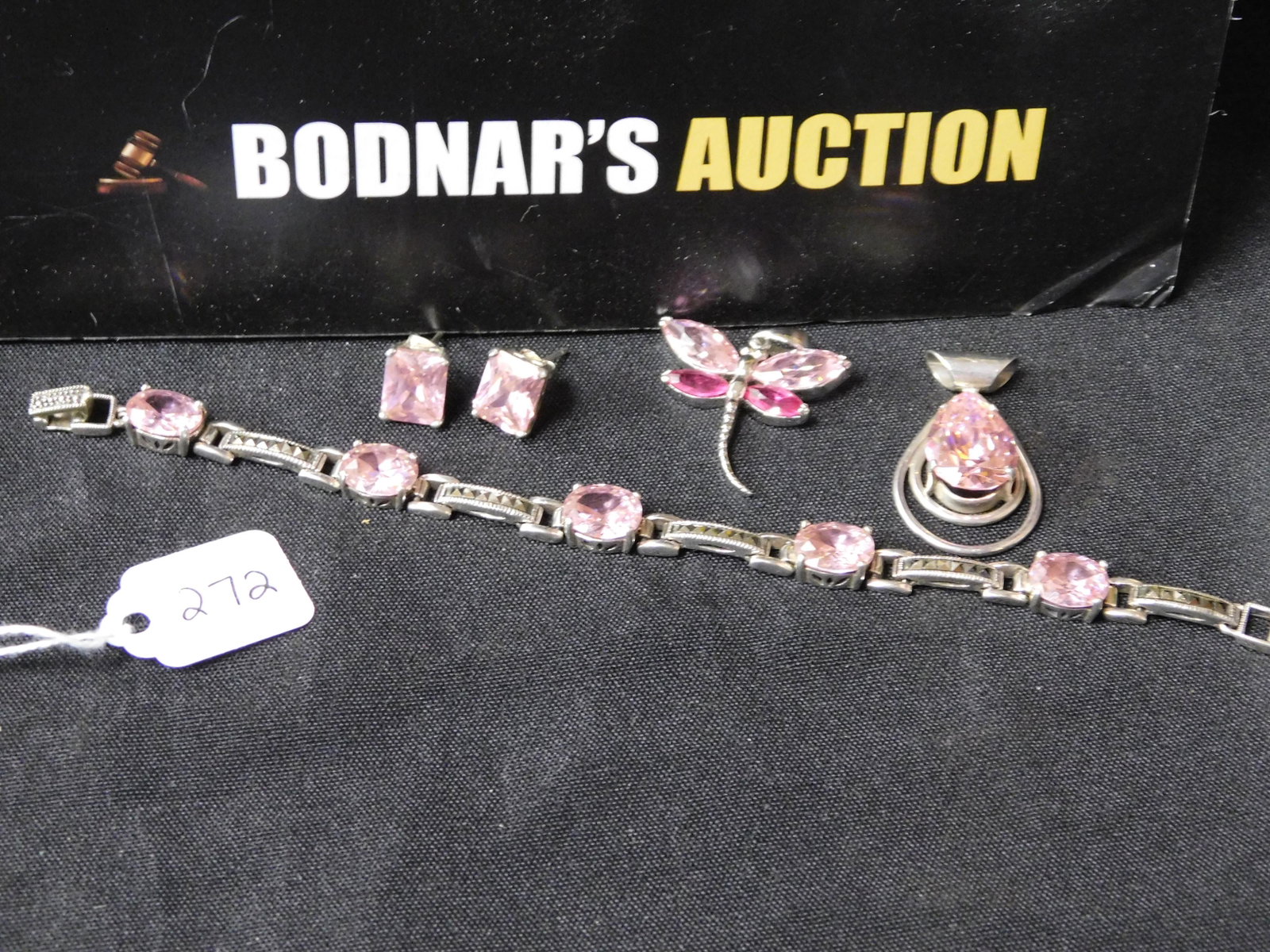 Lot of Sterling Silver & Pink Crystal Jewelry: Lot of sterling silver jewelry set with pink crystals. Bracelet has marcasite accents and is marked on the clasp. Measures approx. 7". Large pendant is not marked but tests as sterling silver. Other p